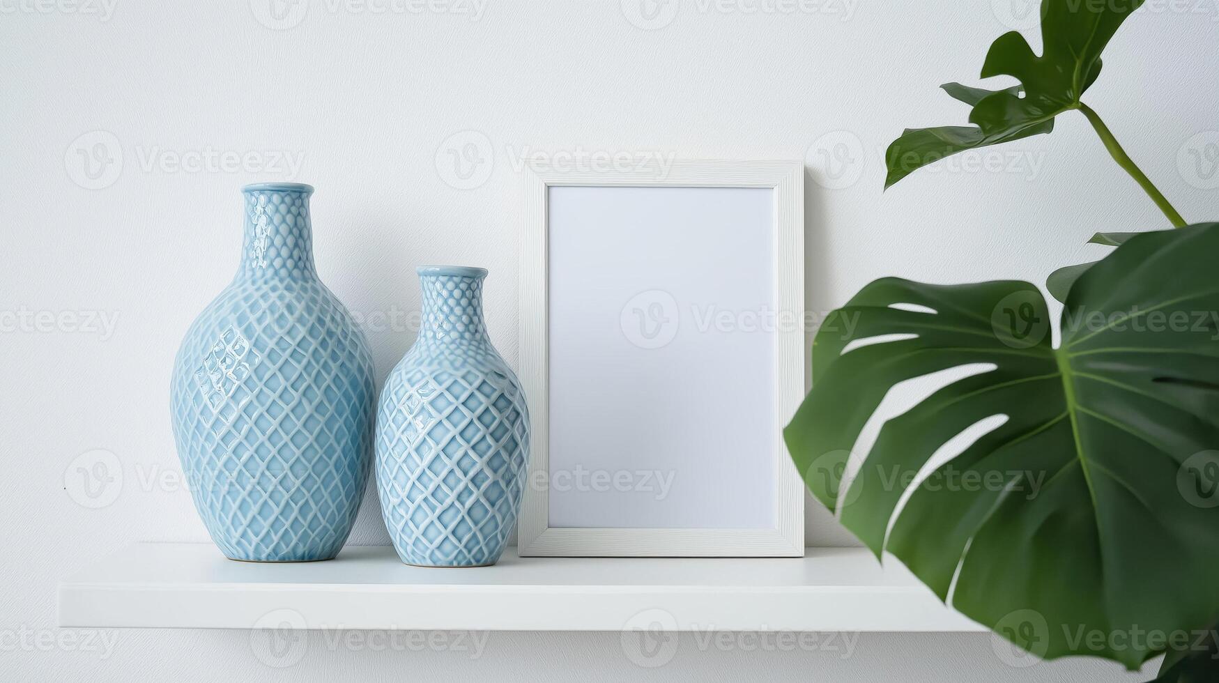 Three vases and a blank frame on a shelf photo