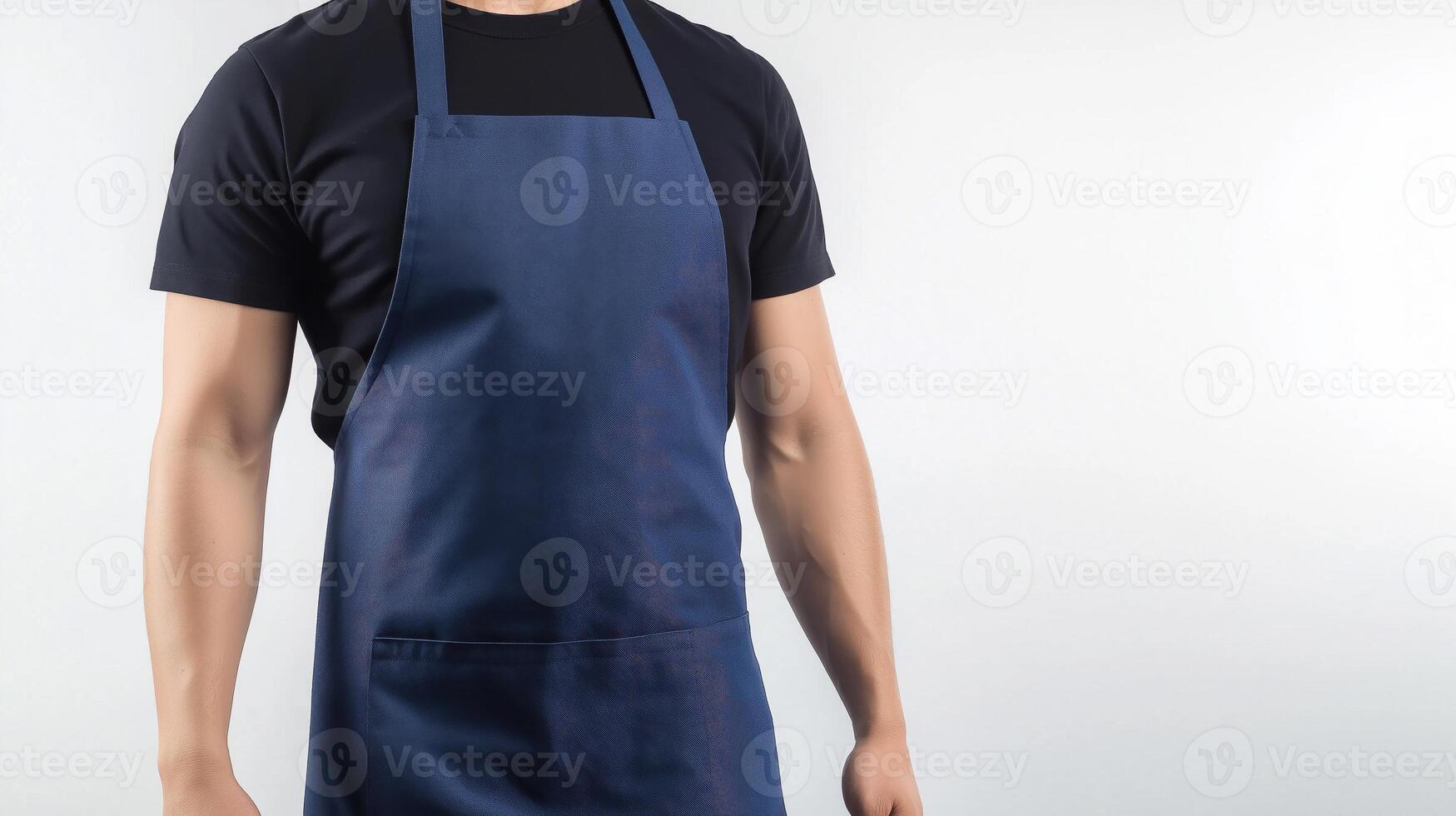 A man in a blue apron with his hands on his hips photo