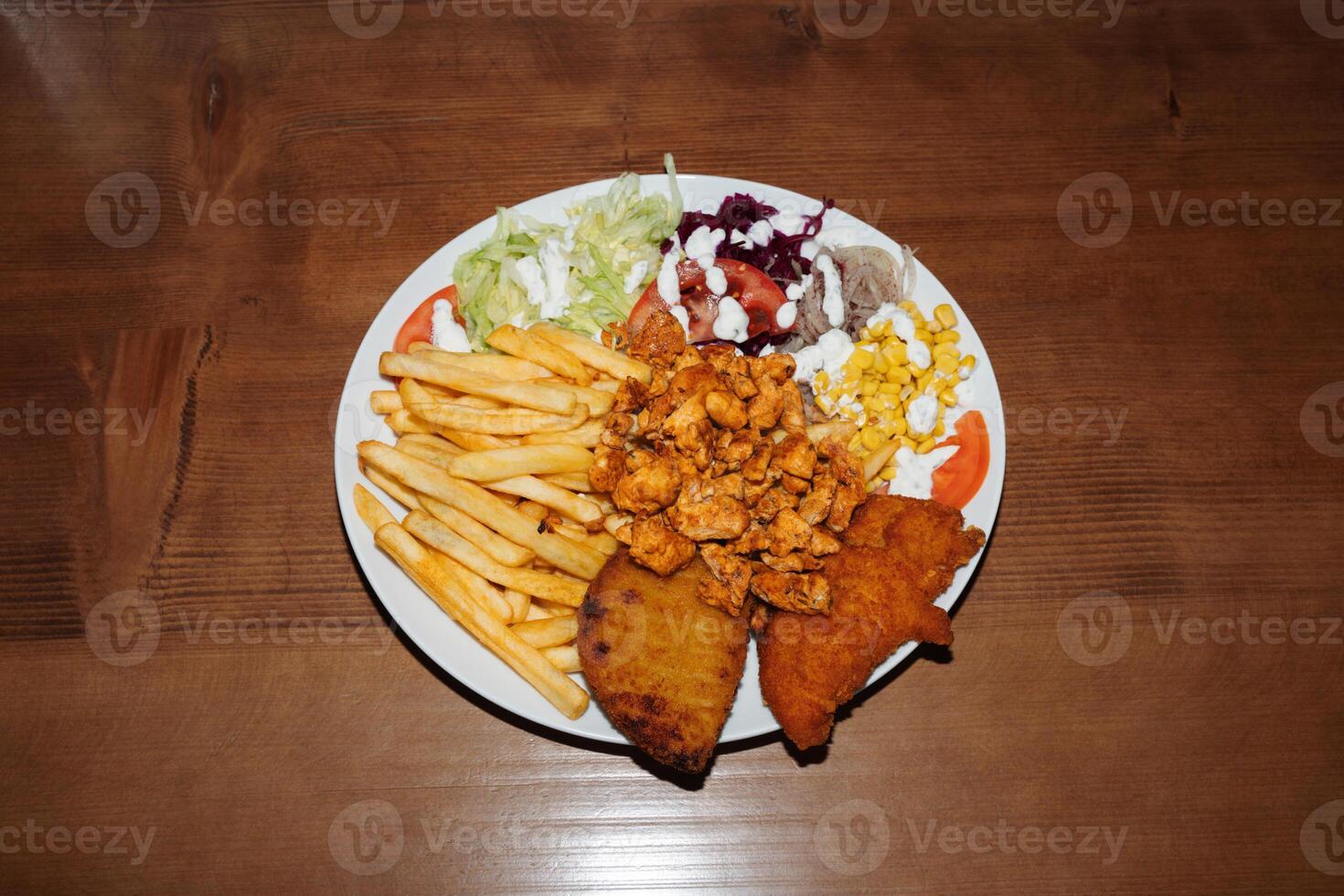 Chicken fries and vegetable salad kebab plate. Turkish restaurant takeout retro flash food photography photo