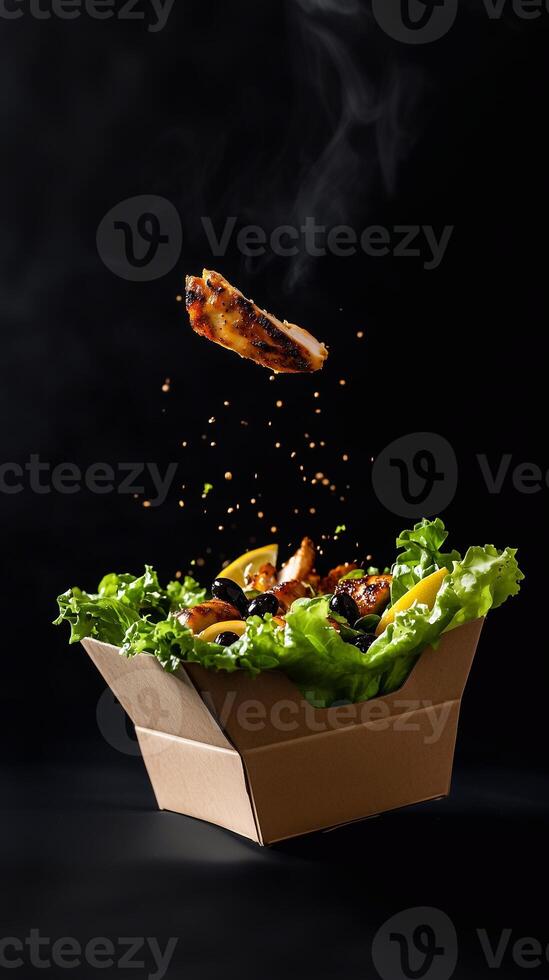 A vibrant grab-and-go salad in an eco-friendly box, featuring fresh lettuce, grilled chicken, olives, and lemon dressing. . photo