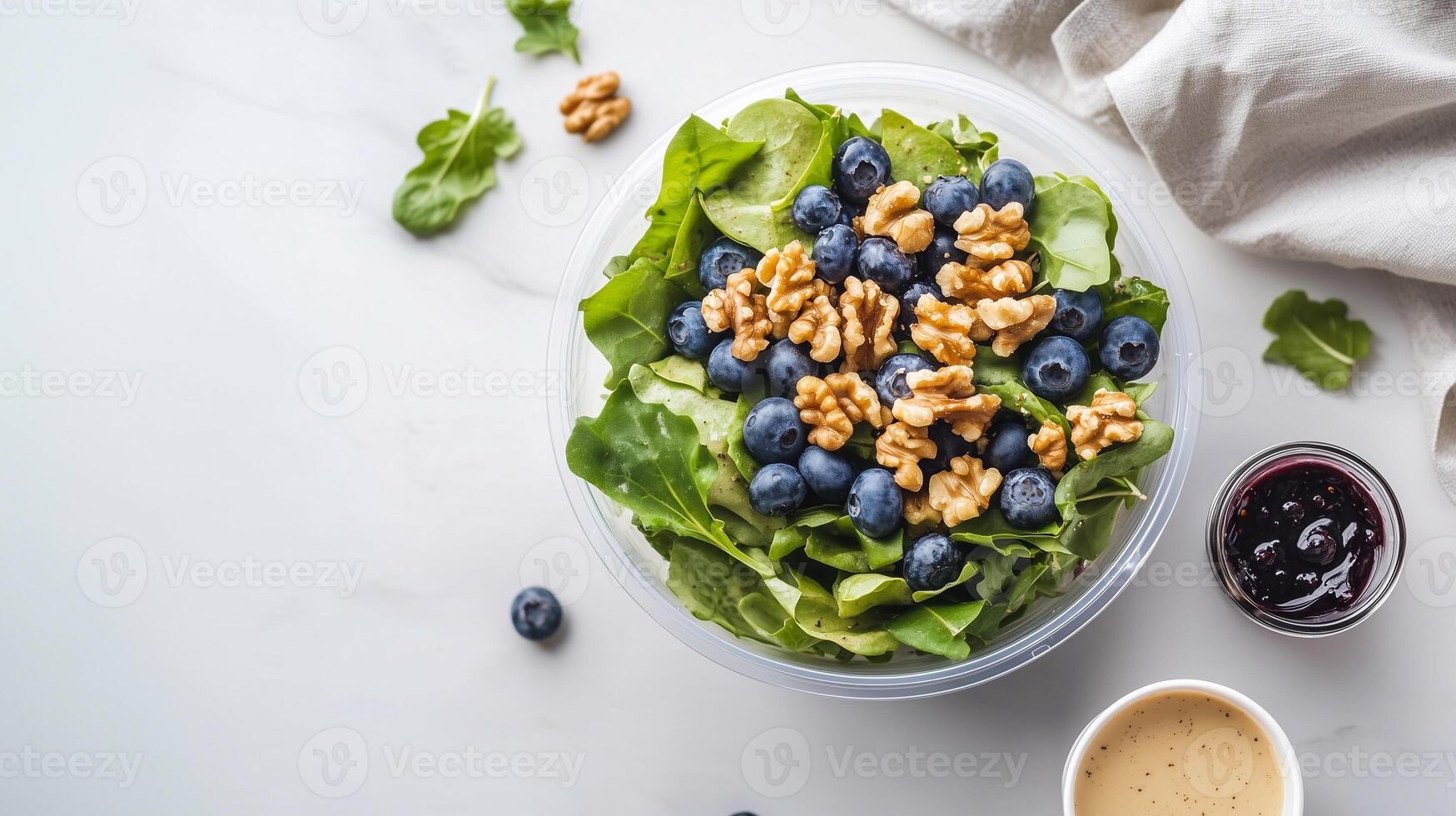 A beautifully arranged fresh salad with walnuts and berries, presented in a bright and modern setting. Grab-and-Go Salad. . photo