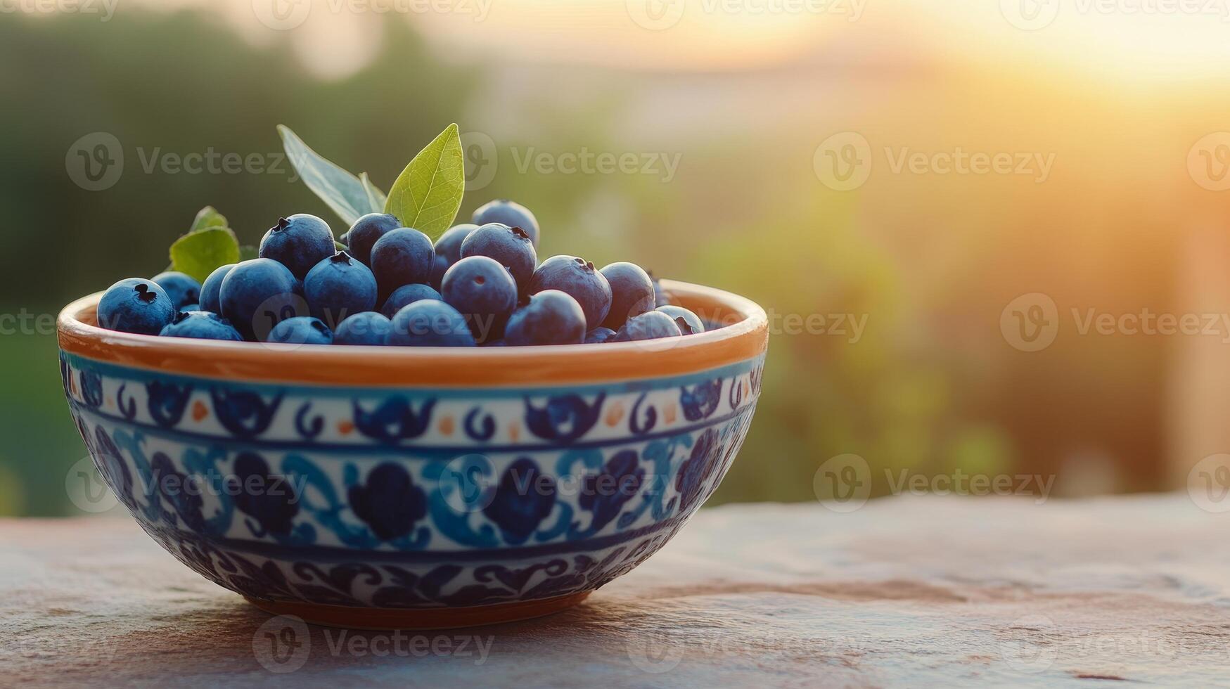 Freshly picked blueberries in a beautiful patterned bowl photo