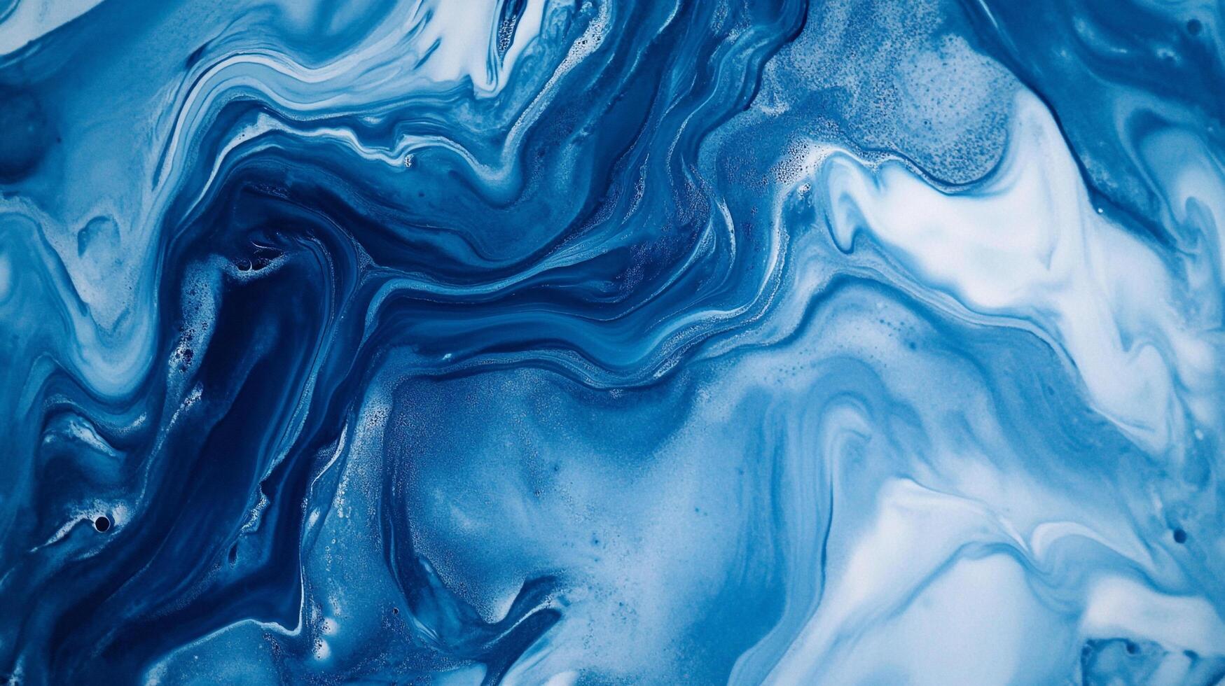 Swirling blues and whites create a captivating abstract pattern reminiscent of ocean waves or marbled textures. Elegant design for many uses. photo