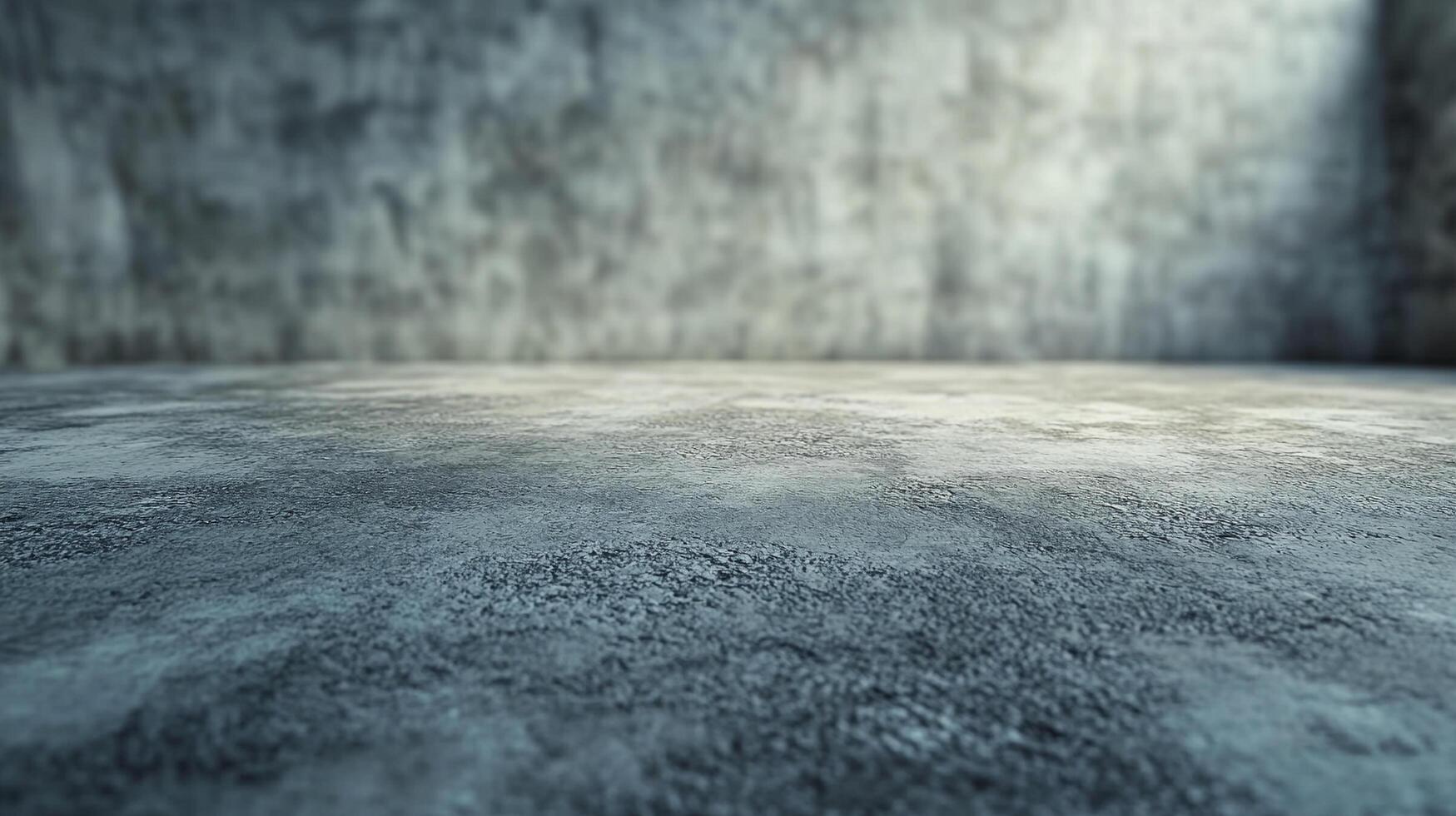 A gritty gray concrete floor fills the foreground, leading to a blurred concrete wall in the background, bathed in soft, diffused light. photo