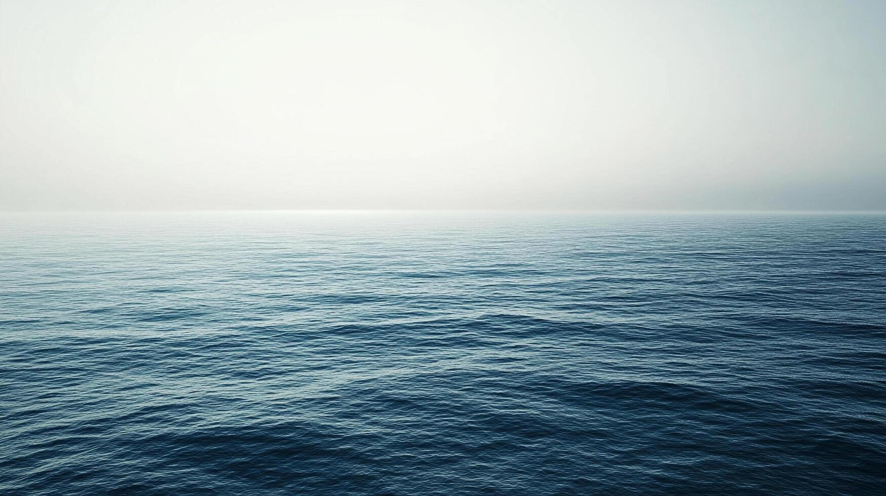 Tranquil seascape capturing the serene expanse of the ocean meeting a soft, hazy horizon under a muted sky, evoking peace. photo