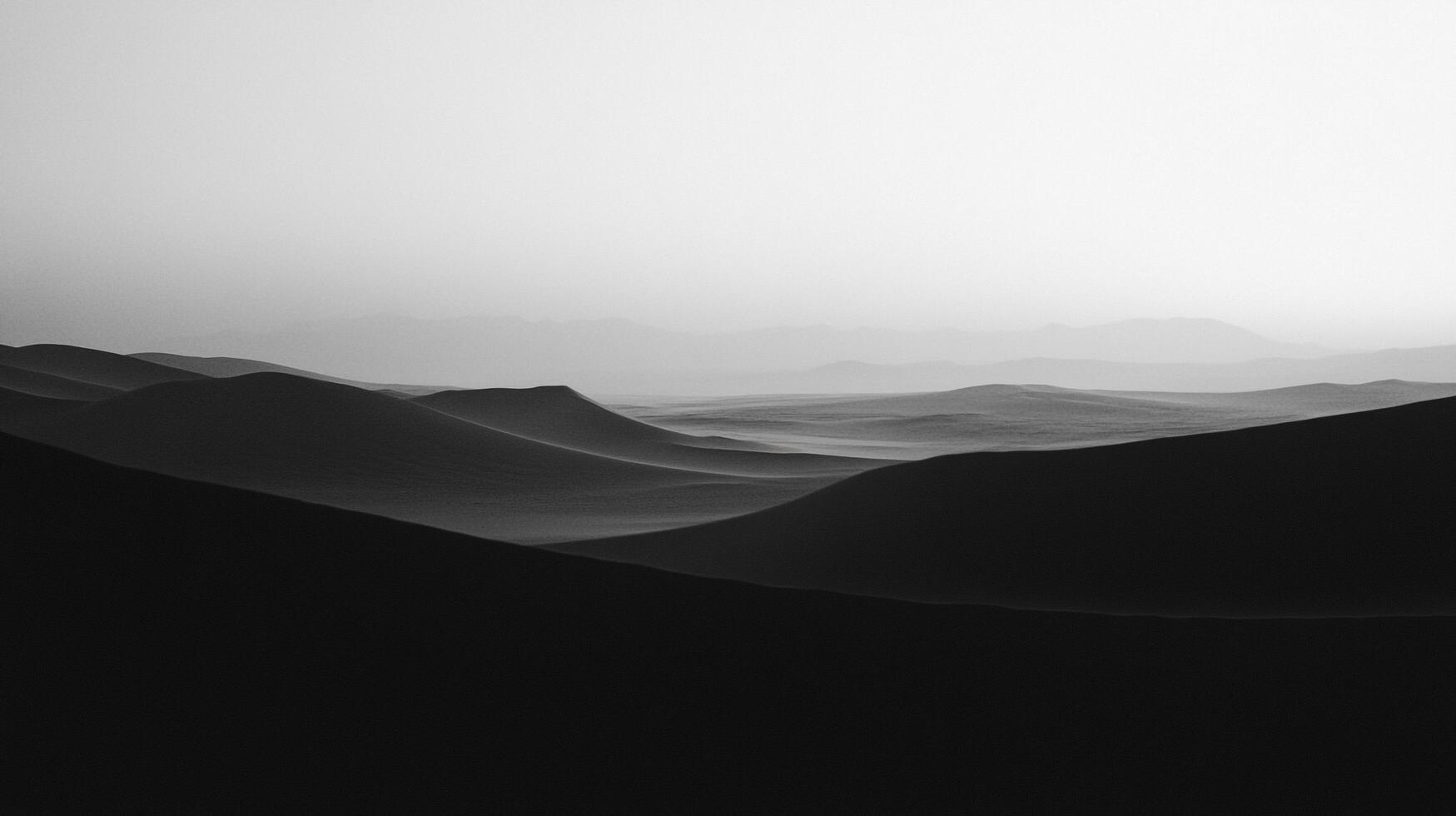 Monochrome desert landscape with rolling sand dunes fading into the distance. A study in light and shadow, stark and desolate beauty. photo