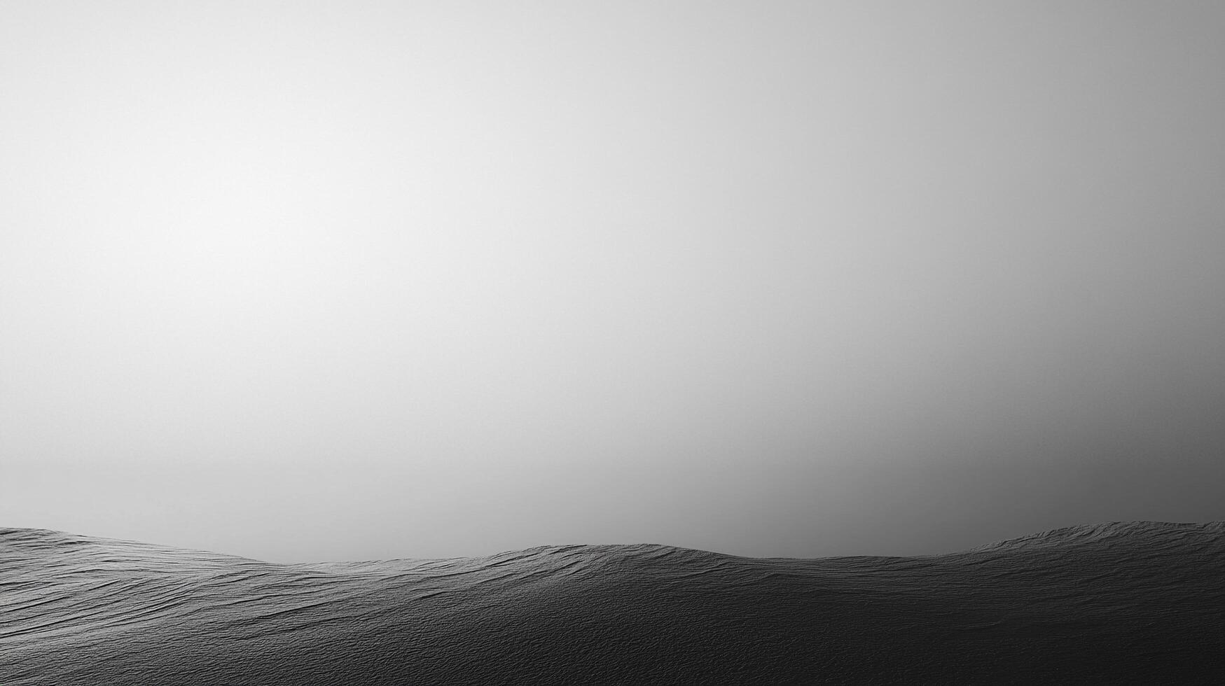 Monochromatic waves undulate in a minimalist landscape, a study in contrasts between dark sea and soft gray sky, capturing nature's elegance. photo