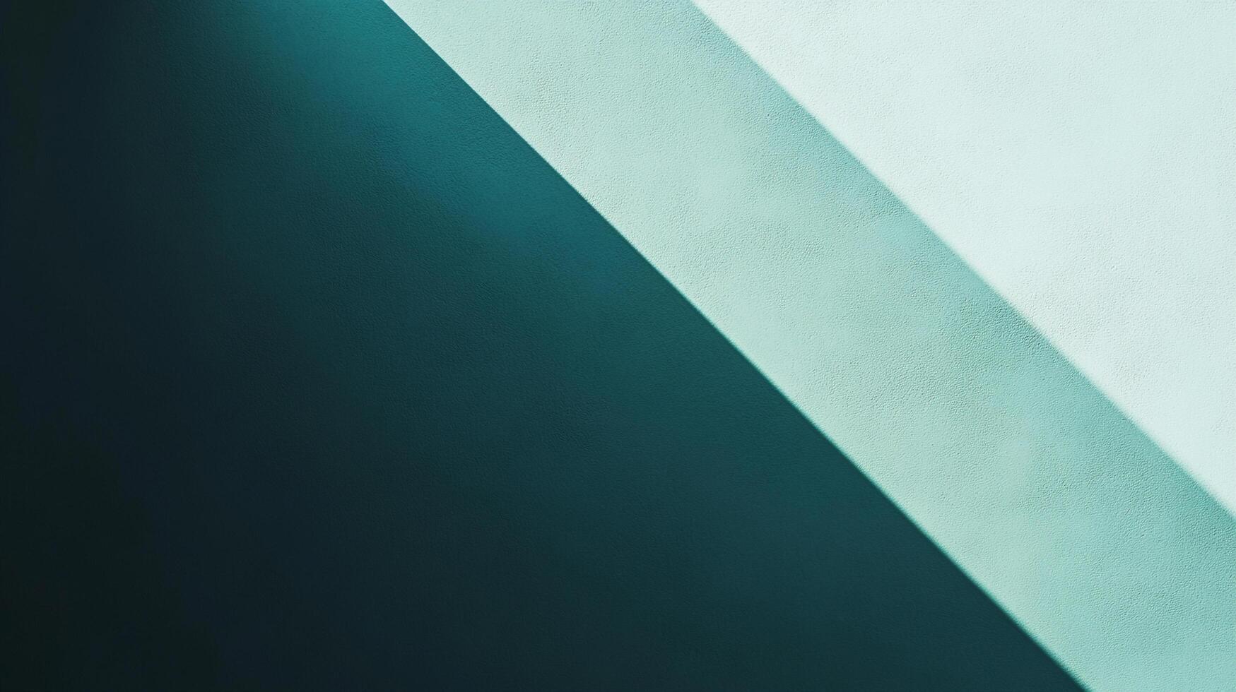 An abstract wall featuring a stark diagonal line separating a dark, cool shadow from a light, slightly warmer painted surface. photo