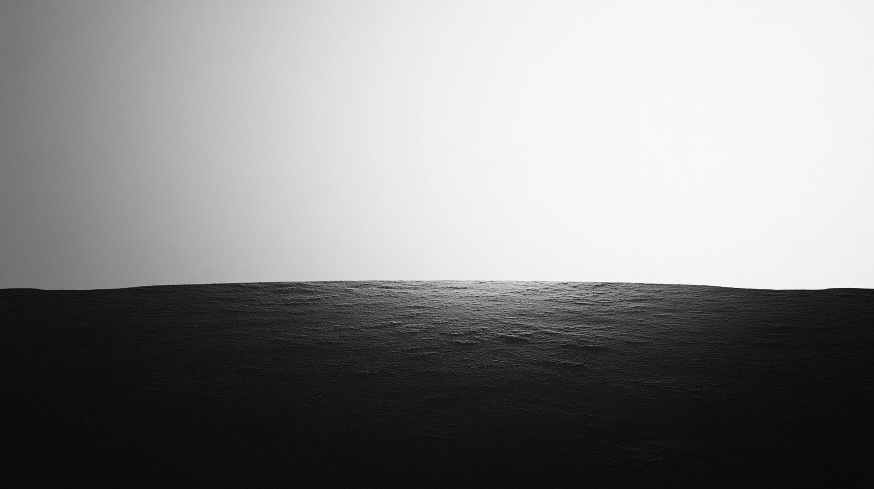 Monochromatic seascape. The undulating water meets the horizon under a bright sky, evoking serenity and vastness in a minimalist scene. photo