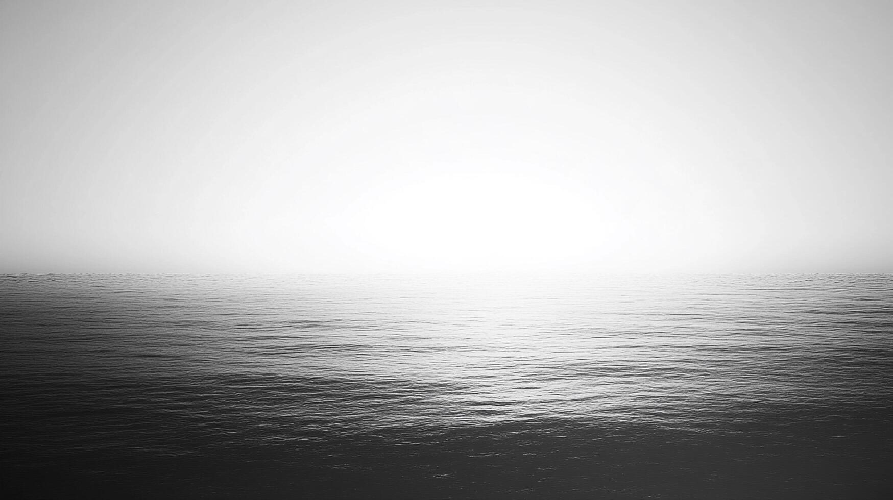 Monochromatic seascape. A calm, hazy sea meets a pale, overcast sky. Atmospheric and ethereal. Serene, simple, minimalist scenery. photo