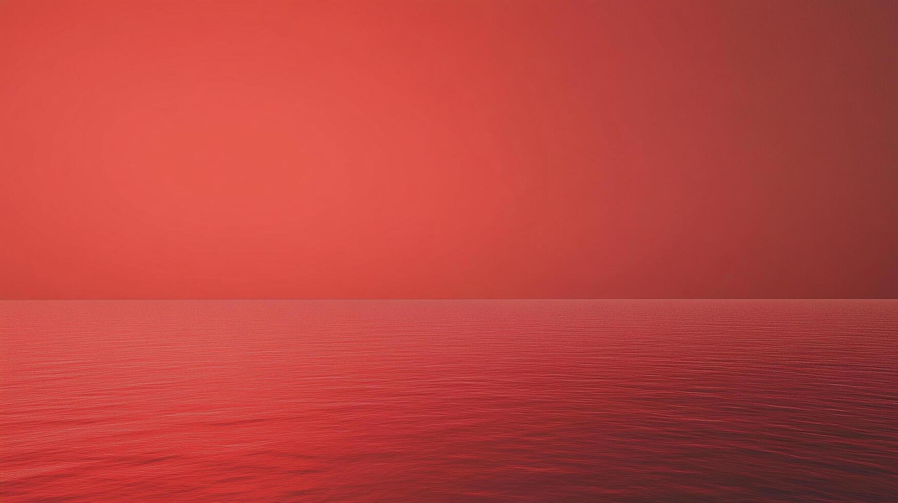 A monochromatic sunset illuminates a still ocean with a smooth gradient of intense red light, creating a serene and surreal scene. photo