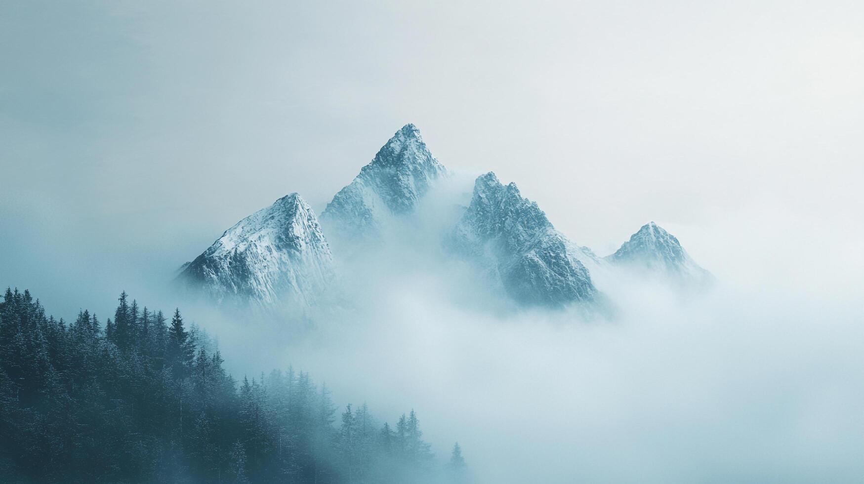 Mountains pierce through fog, snowy peaks and evergreens, a serene landscape of wilderness. Nature's beauty in a misty atmosphere. photo