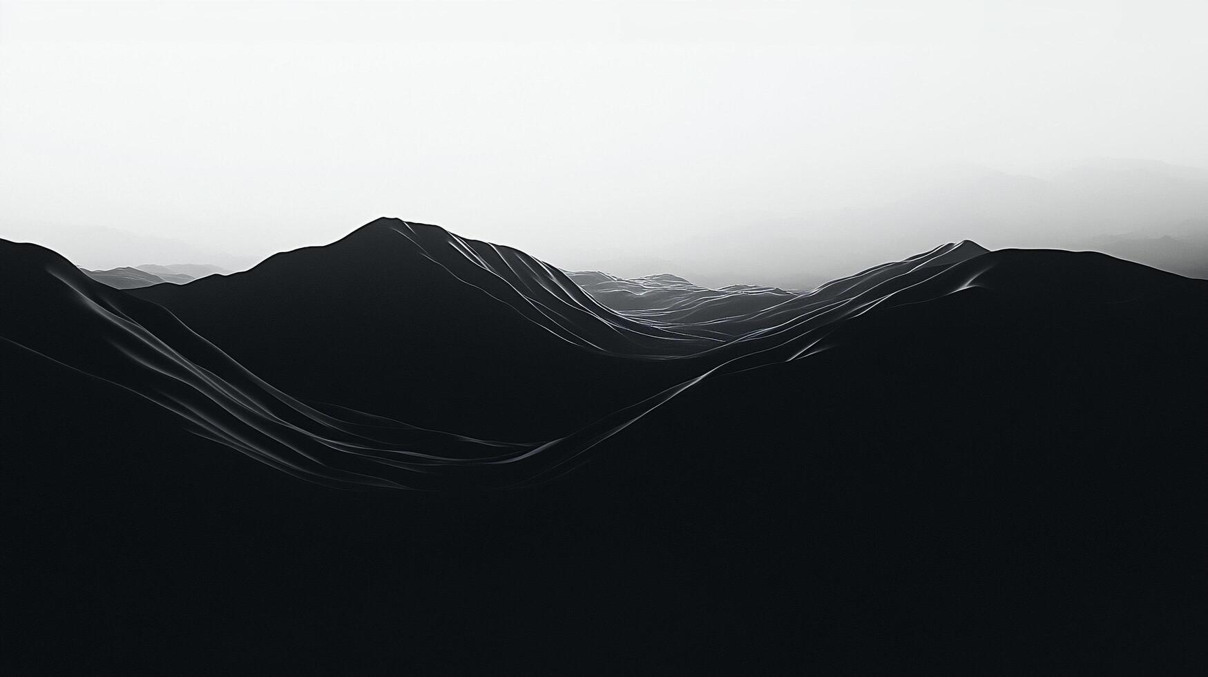 Monochromatic landscape featuring dark mountain ridges receding into the horizon under a bright sky, creating a sense of depth and vastness. photo