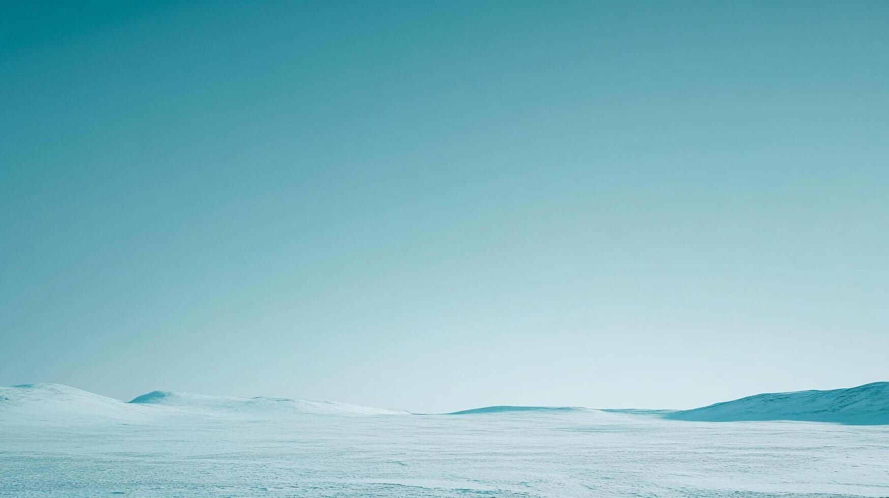 Monochromatic arctic scene with snowy plains meeting a clear teal sky, evoking a sense of peace and remote solitude in the vast landscape. photo
