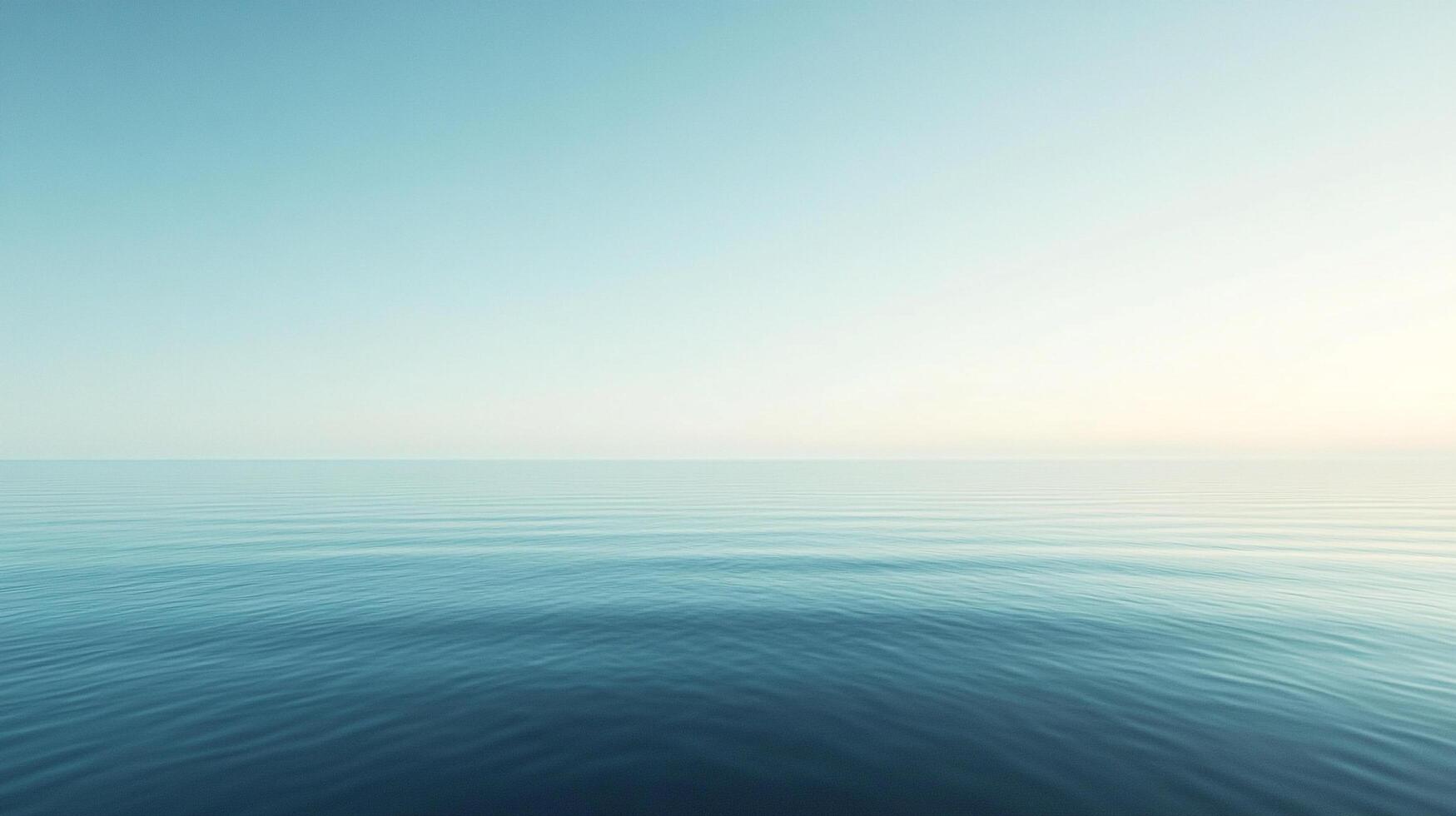 Tranquil sea reflects soft, muted sky. Calm ocean surface with subtle ripples evokes peace. Perfect for meditation or relaxation. photo