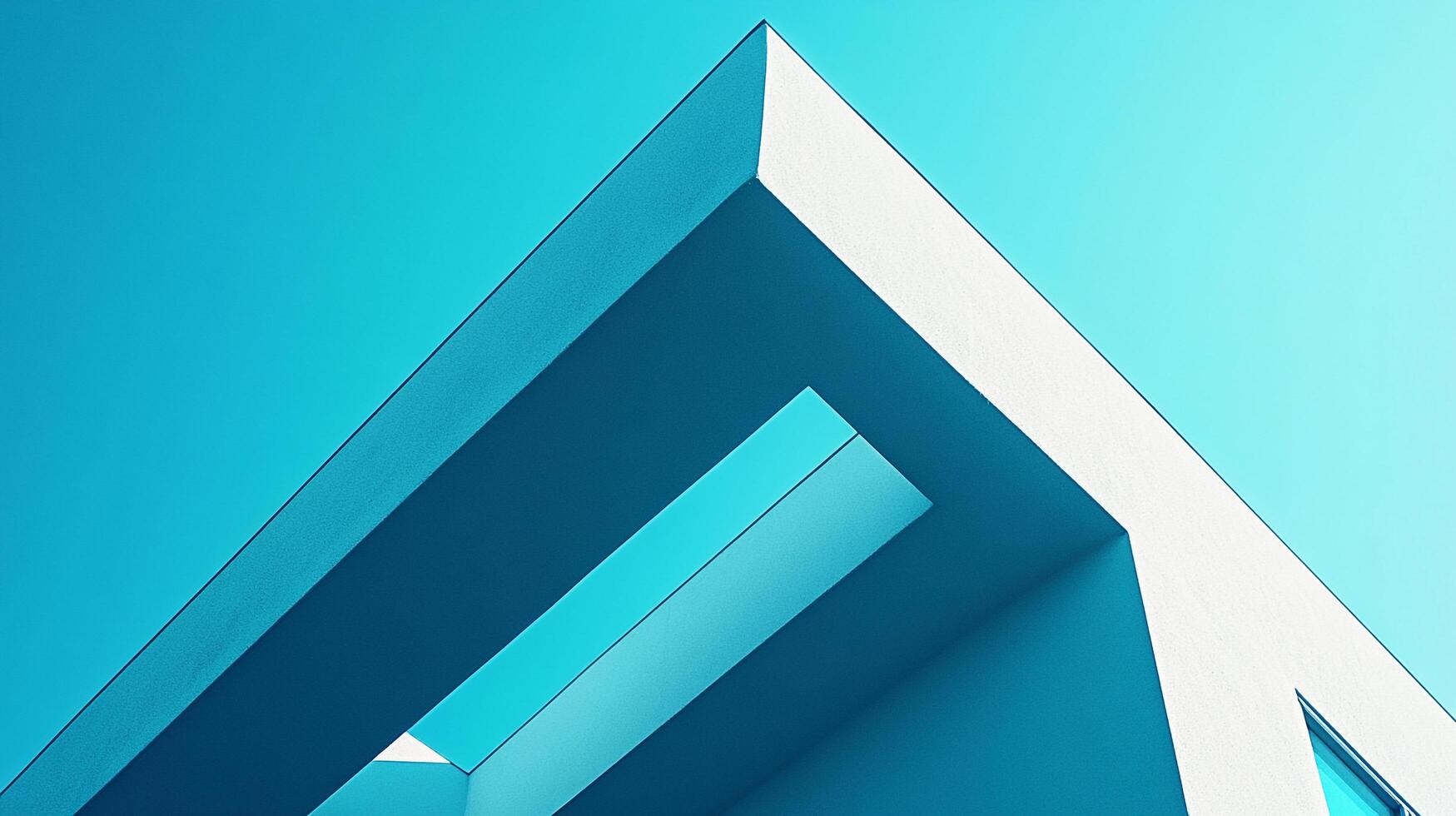 Angular architecture intersects with a vibrant sky, casting shadows that emphasize the building's geometric design against the blue backdrop. photo