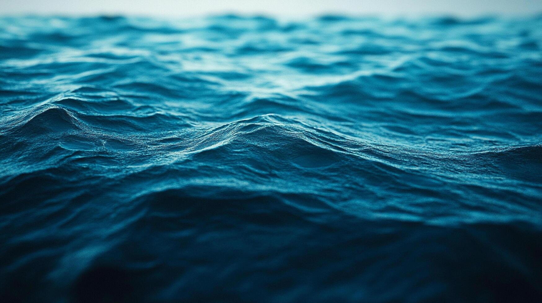 Mesmerizing ocean waves roll gently under a serene sky, creating a calming and captivating seascape of deep blue hues and rippling water. photo
