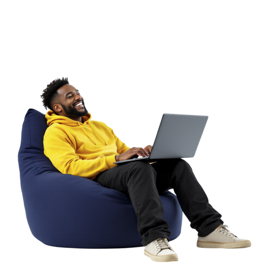 A man sitting on a bean bag chair with a laptop png