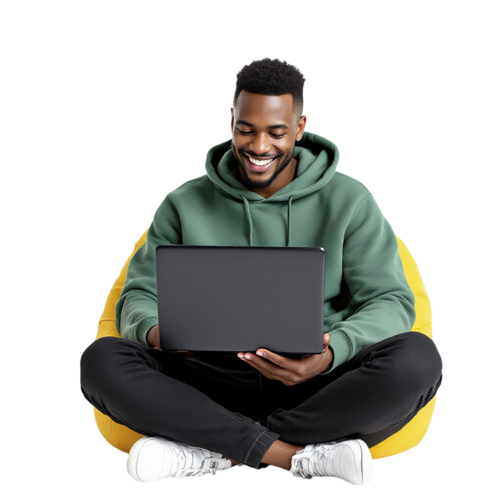 A man in a green hoodie is sitting on a bean bag and using a laptop png
