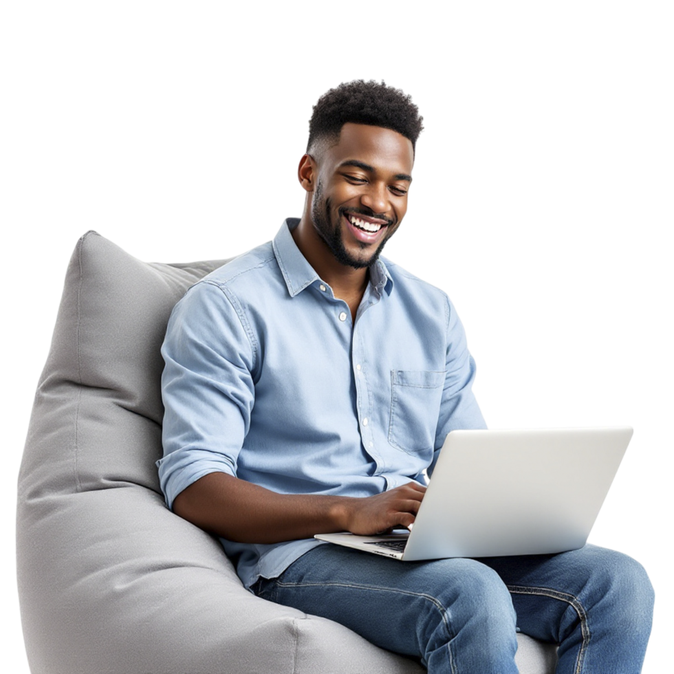A smiling man sitting on a bean bag chair with a laptop png