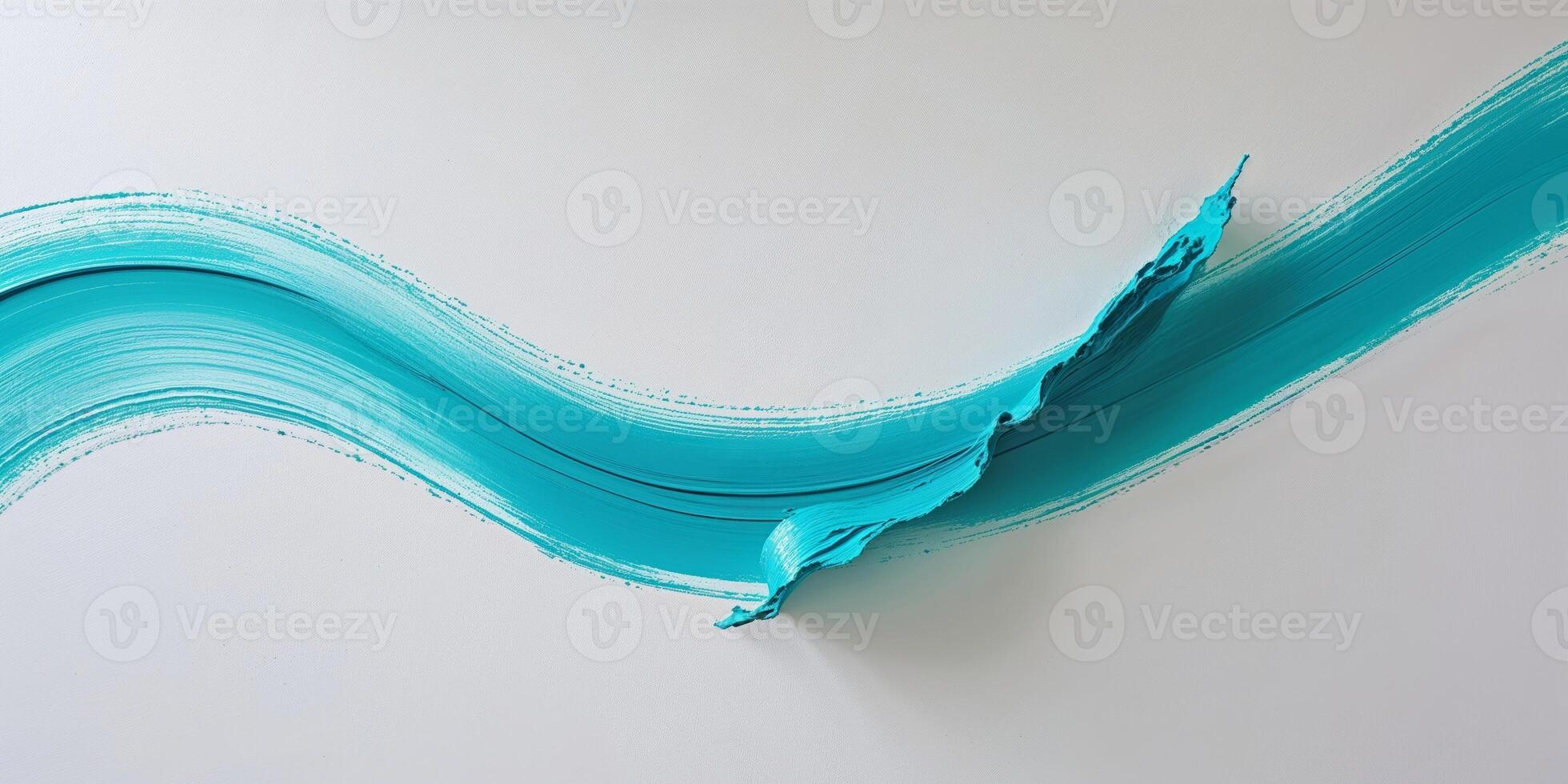 Abstract shape formed by a turquoise acrylic brush stroke on a blank canvas photo