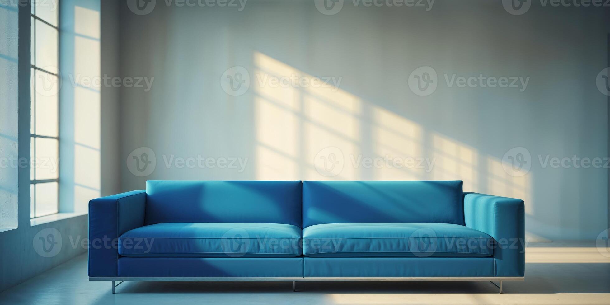 A blue couch in front of a window photo