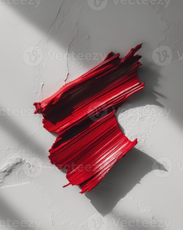Brush stroke in deep red with a textured surface photo
