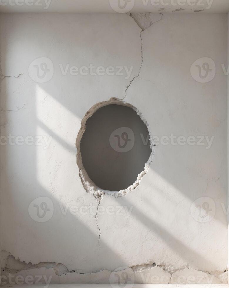 A distressed white wall featuring an unusual hole that adds character and intrigue to the setting. photo