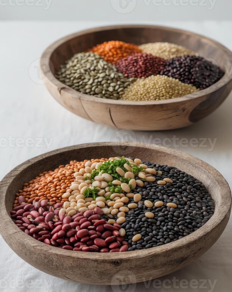 Beans and lentils of different varieties fill two wooden bowls offering a variety of textures and colors photo