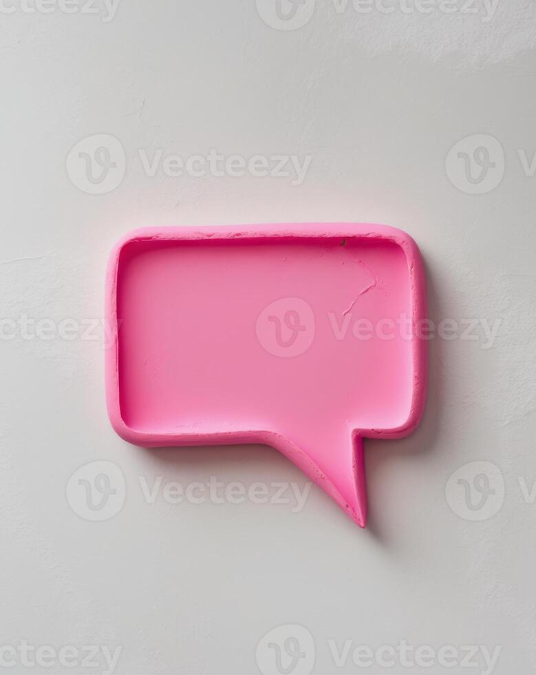 Pink speech bubble plasticine in a textured rectangular shape with a pointed tip photo
