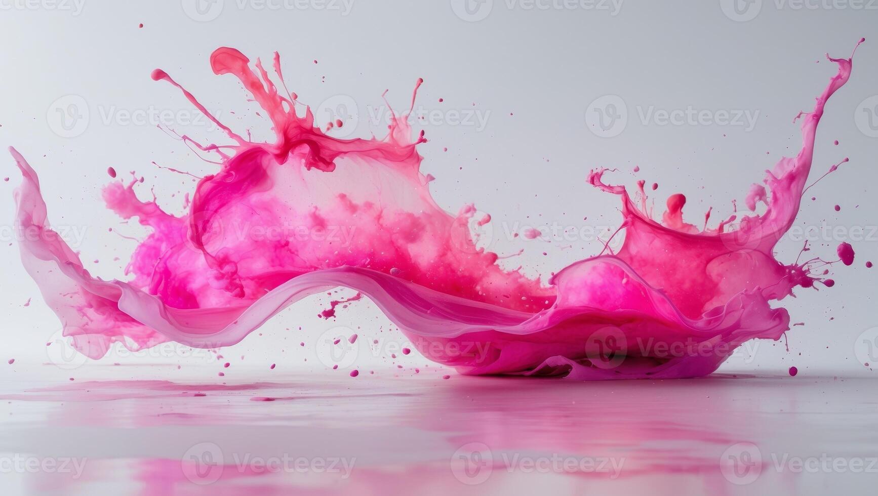 Watercolor shape with splattered pink hues creates a dynamic and expressive design element. photo