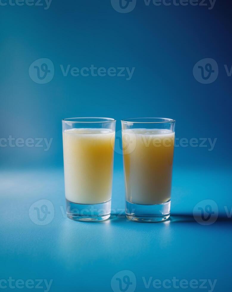 Glasses of fresh apple juice on blue background photo