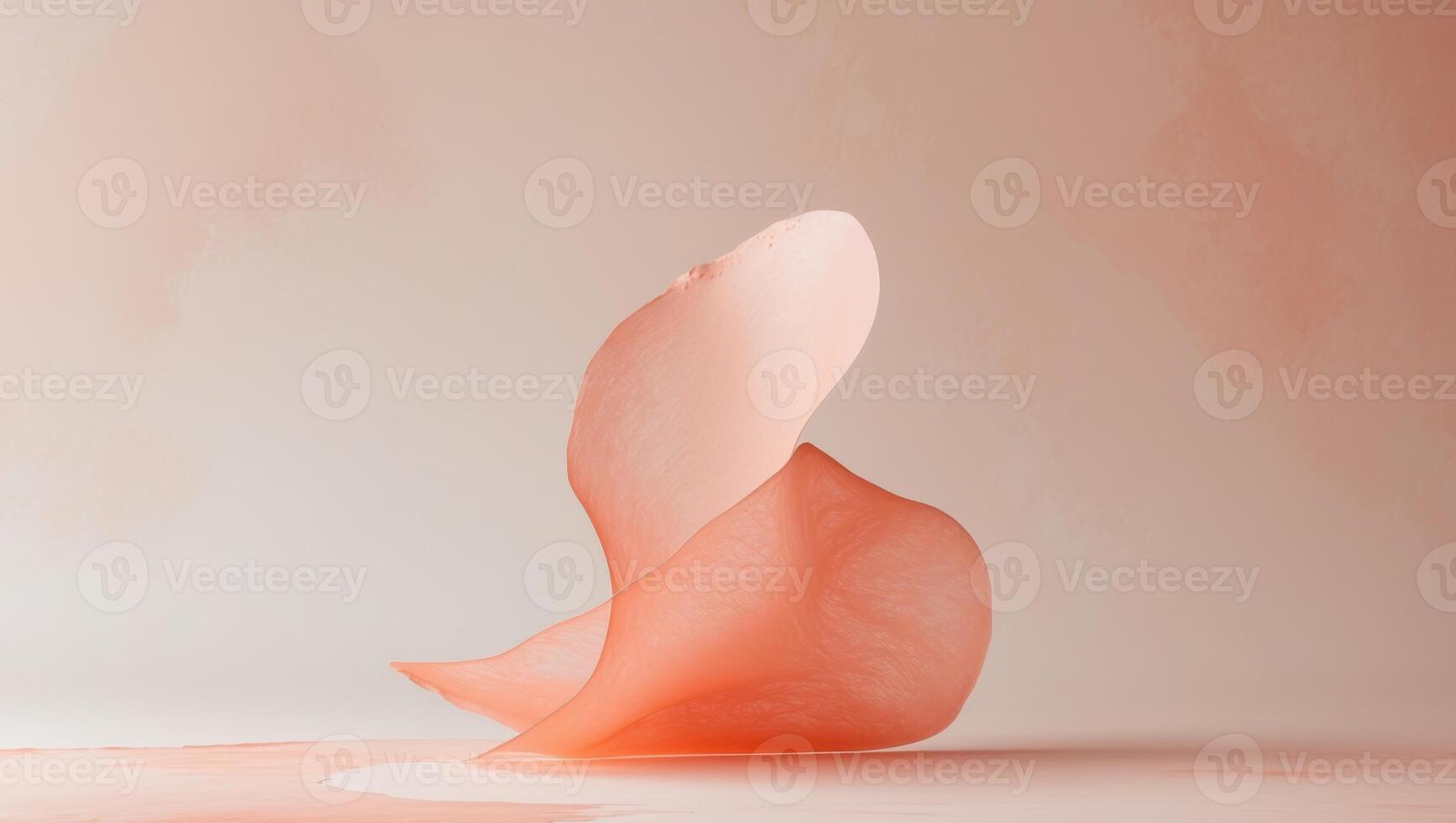 Watercolor brush stroke in soft peach and coral hues creates a delicate and textured abstract shape photo