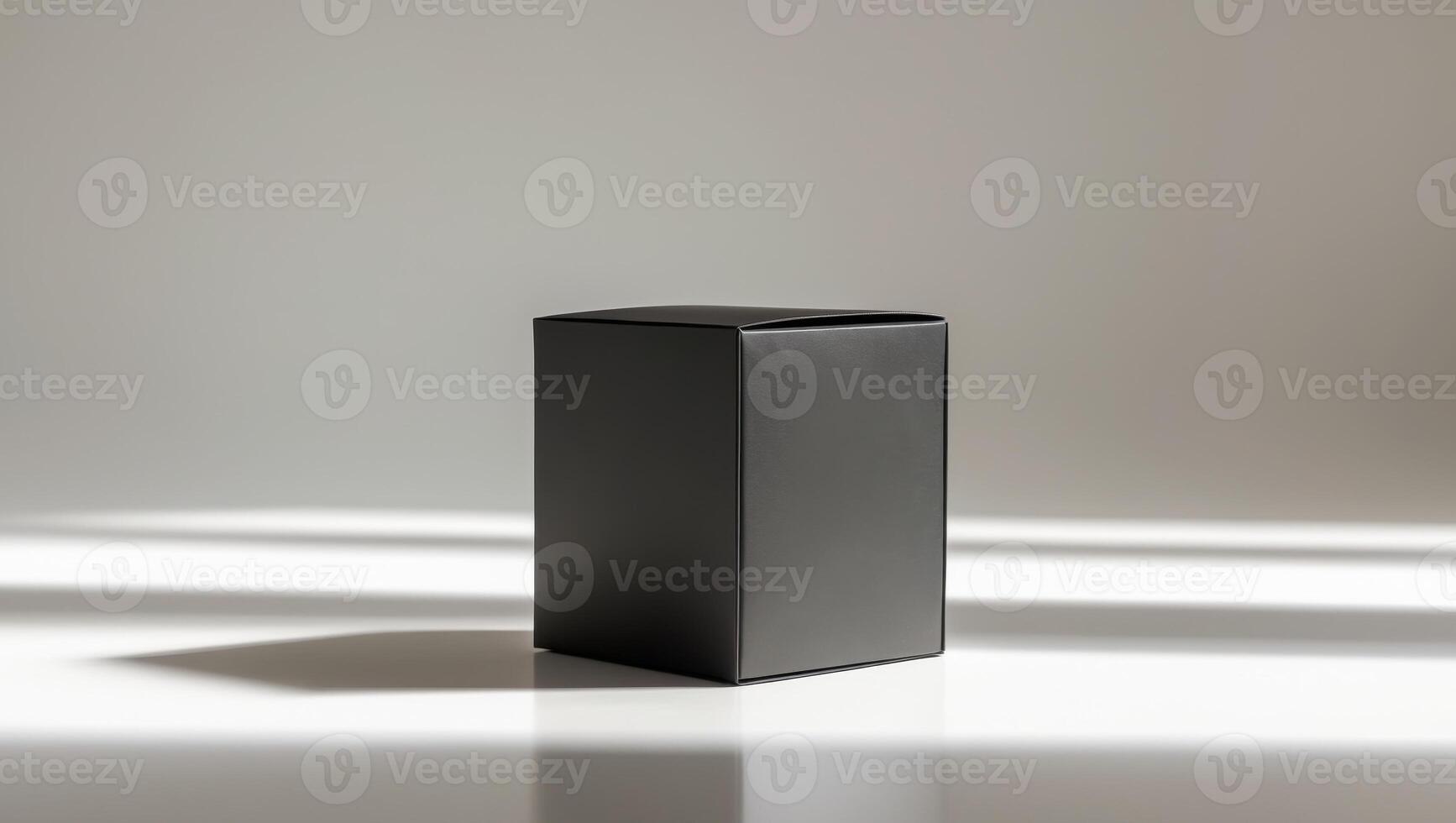 Premium black matte packaging box on reflective surface with subtle shadows for branding showcase photo