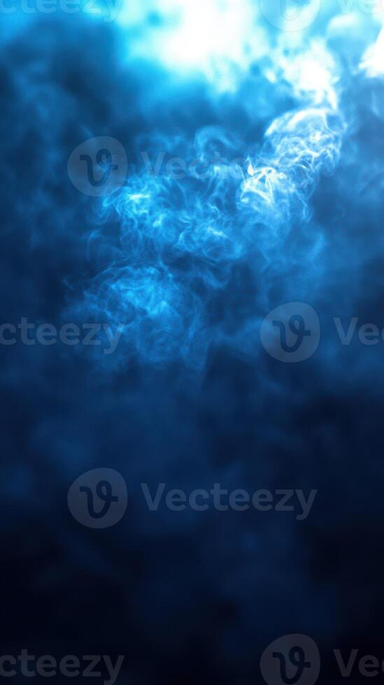Atmospheric blue smoke swirling in a mysterious shadowy background creating a captivating visual effect photo