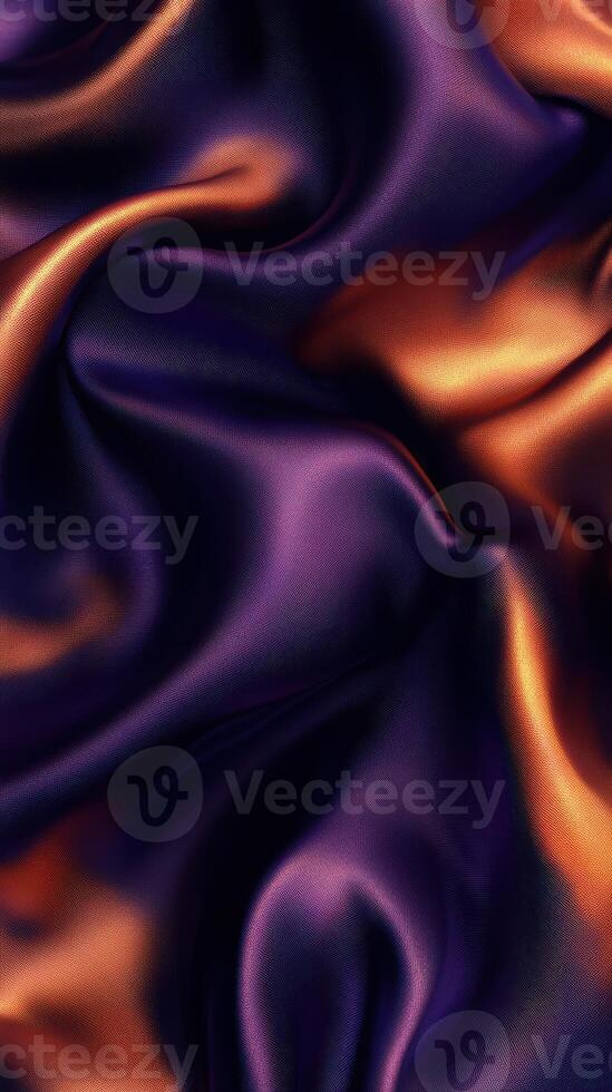 Richly textured purple and orange silk fabric draped softly to create elegant waves and luxurious patterns photo