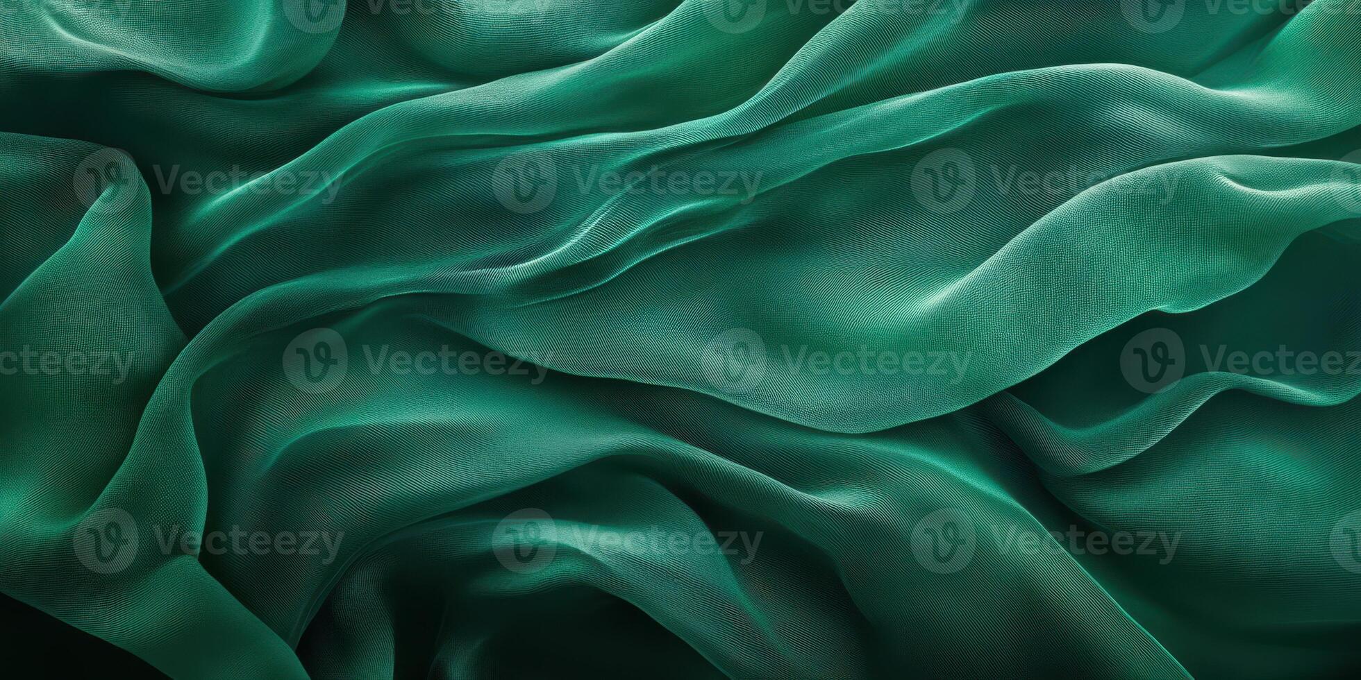 Elegant turquoise fabric waves flowing softly in a gentle pattern under studio lighting photo