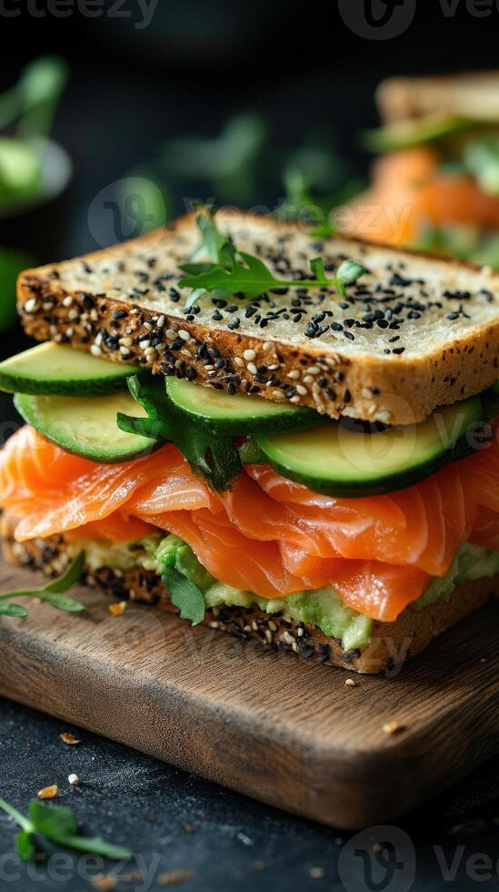 Delicious healthy sandwich with fresh salmon, avocado, and cucumber on whole grain bread photo