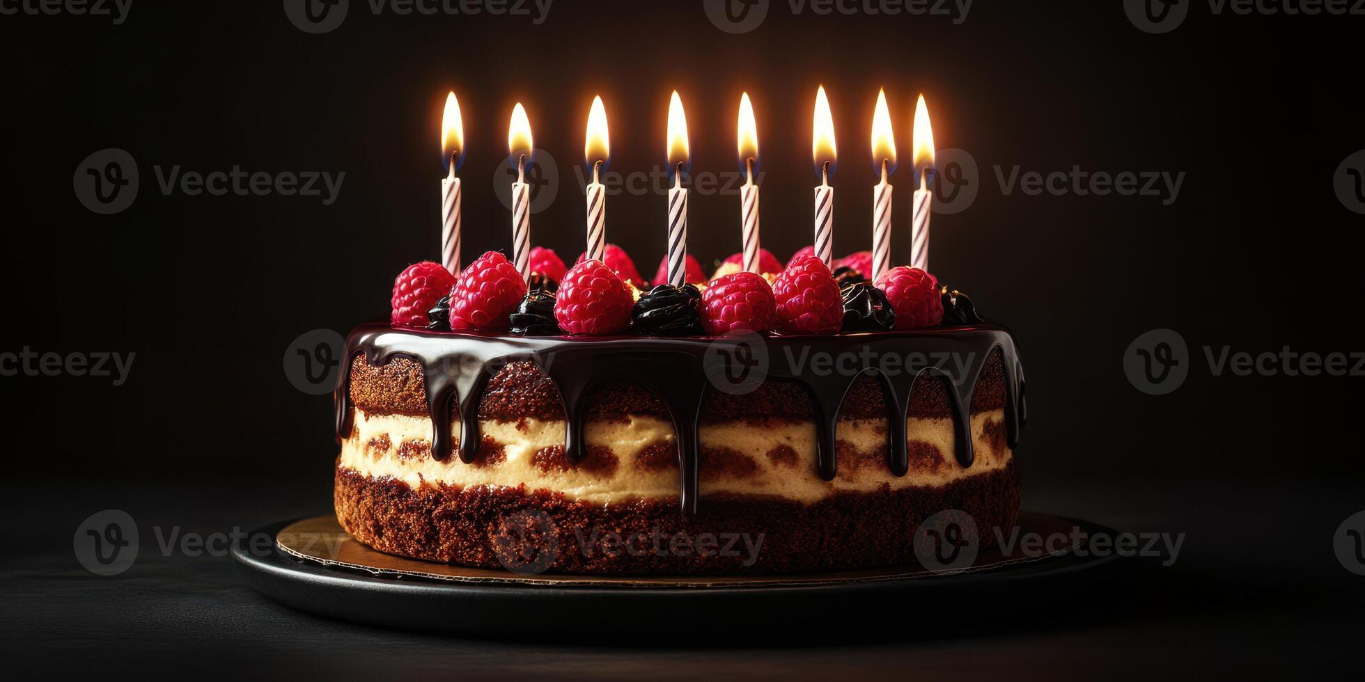 Delicious chocolate cake with raspberry topping and candles lit for celebration at a festive gathering photo