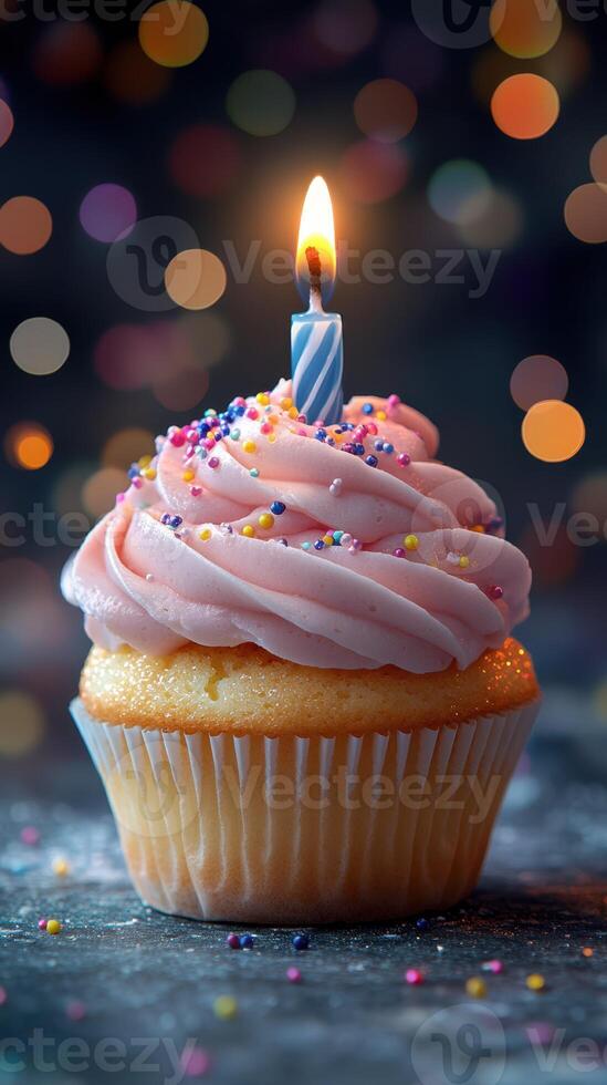 Delicious pink frosted cupcake with a lit candle, celebrating a special occasion at a festive setting photo