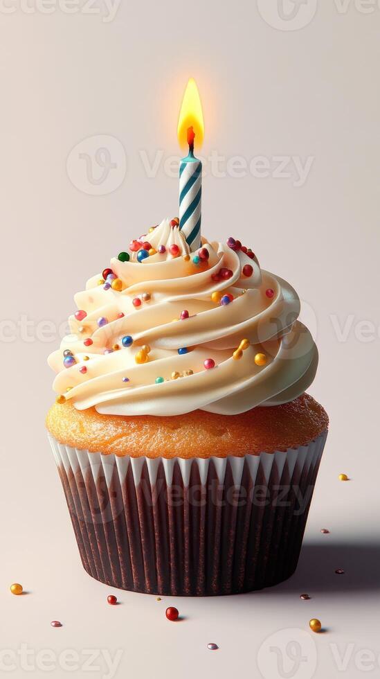 Delightful cupcake with cream frosting and a lit candle for celebration photo
