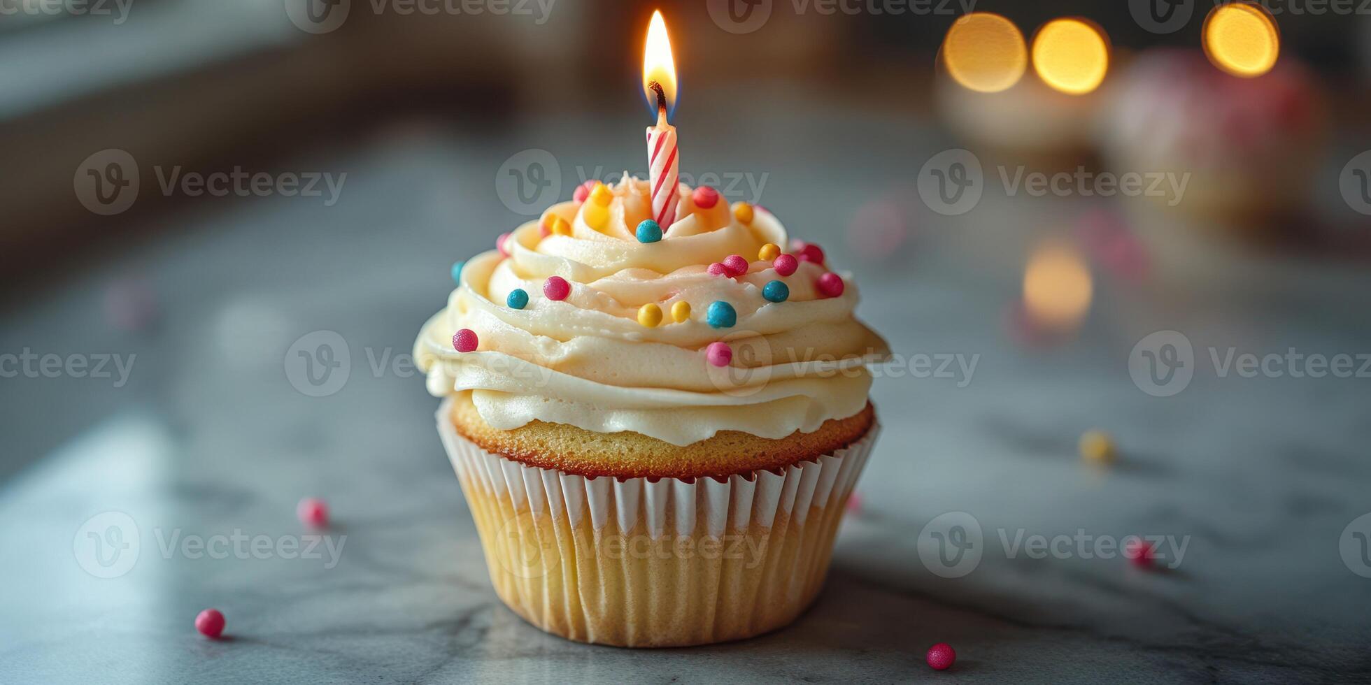 Colorful cupcake with a candle on a marble surface for a birthday celebration indoors photo
