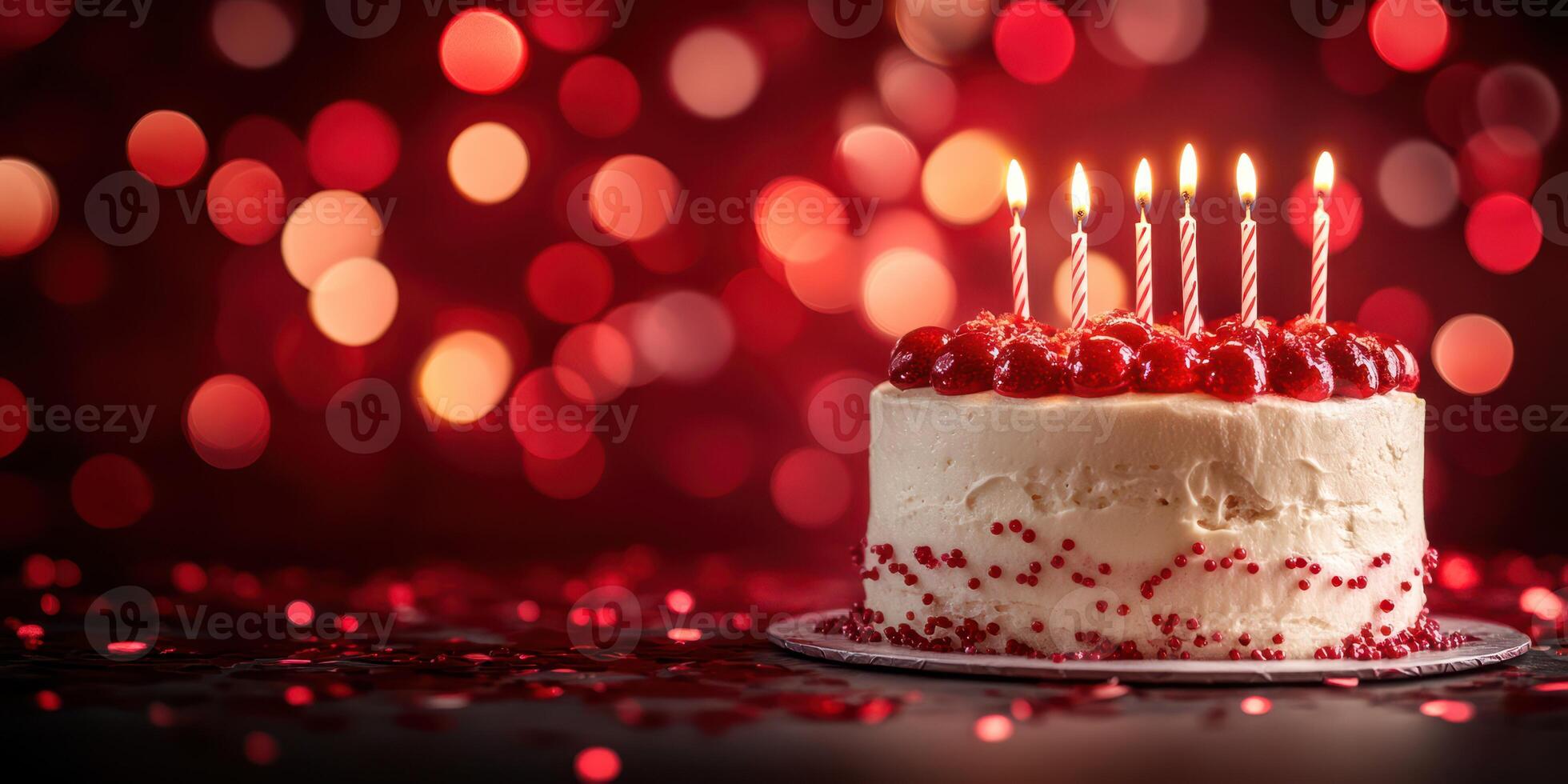 Celebration cake with lit candles and festive background during a joyful birthday party photo