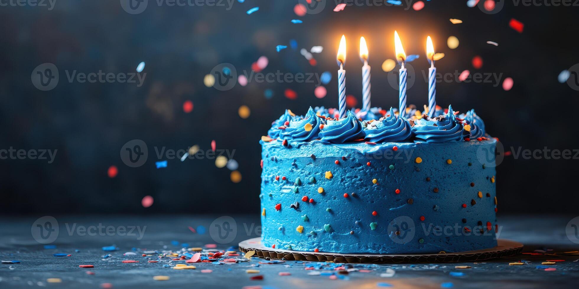 Colorful birthday cake with candles illuminated and confetti scattered on a festive background photo