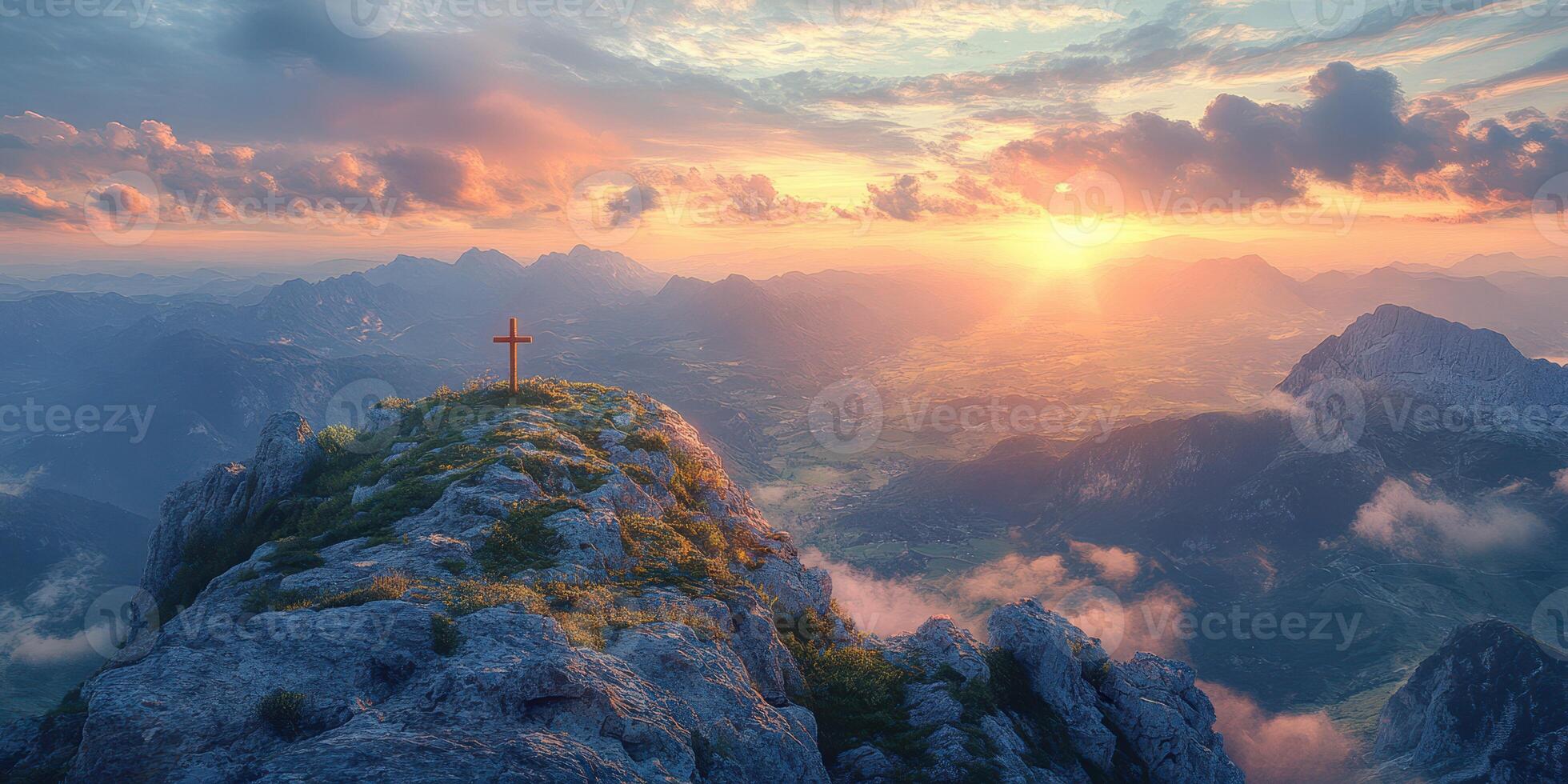 Sunset view from mountain peak with cross overlooking valley and distant mountains in soft light photo