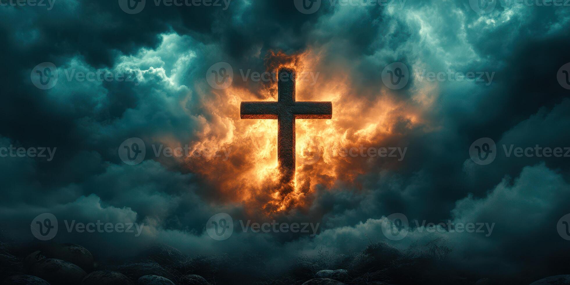 Powerful cross illuminated by fiery clouds in a dramatic sky at twilight photo