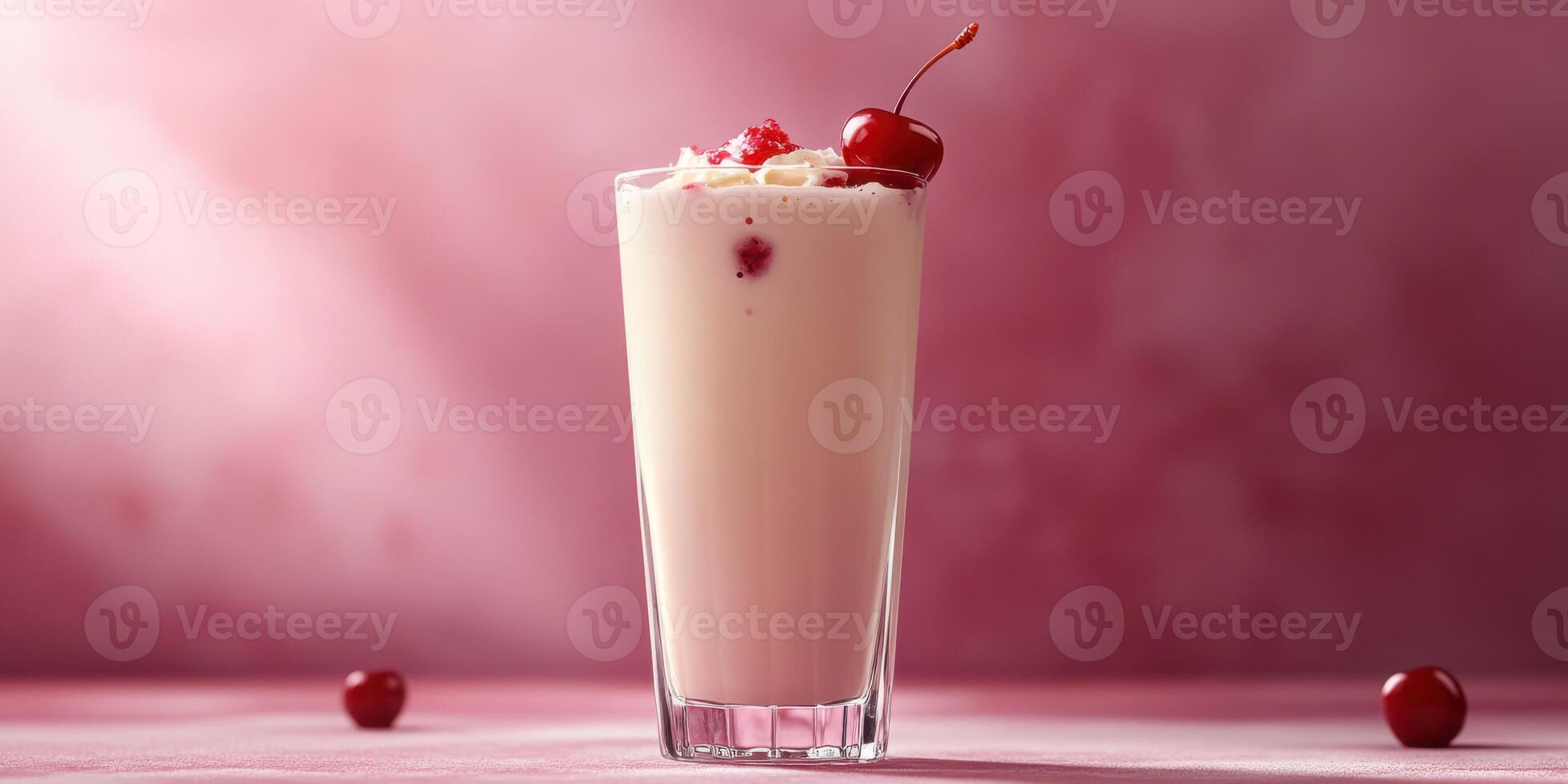 Delicious cherry milkshake topped with whipped cream and cherries served against a soft pink backdrop photo