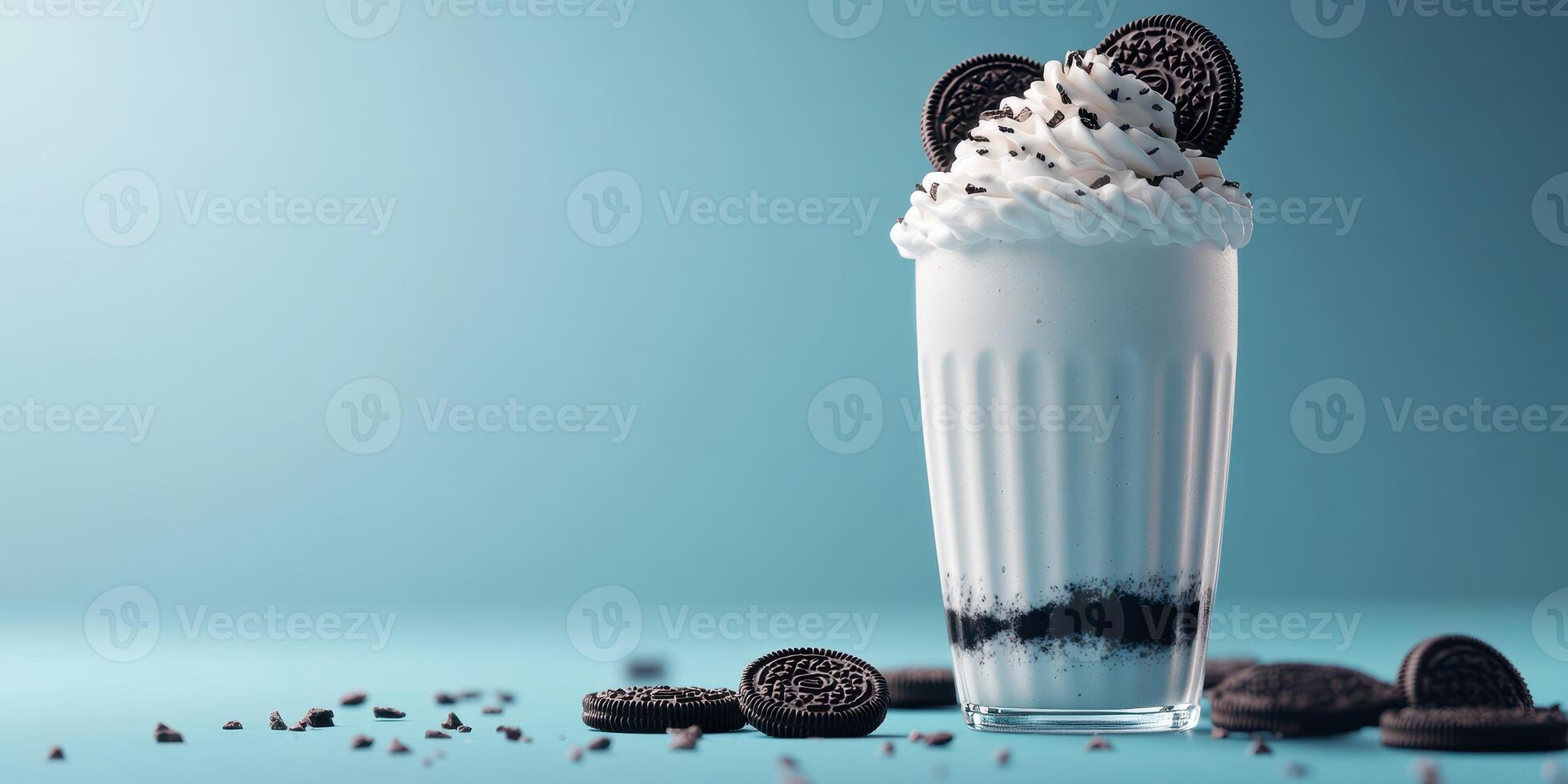 Creamy dessert drink topped with cookies and whipped cream on a blue background photo