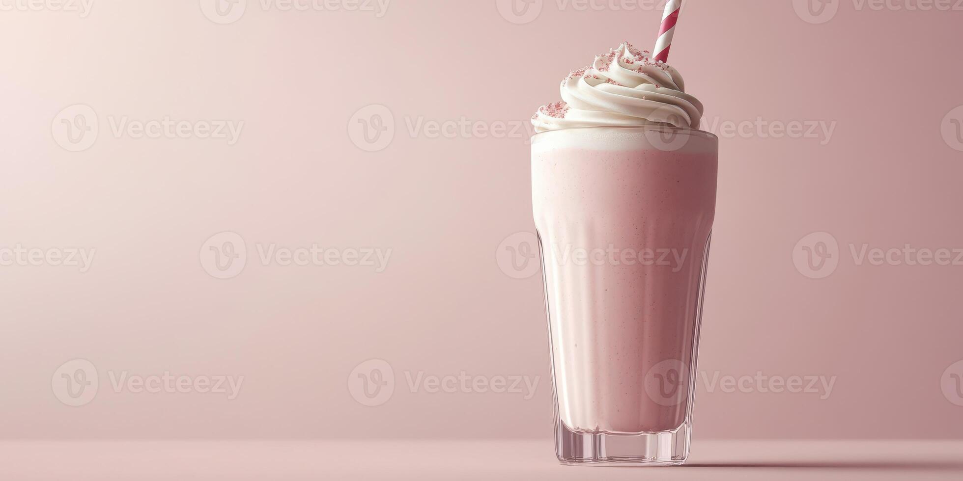 Delicious milkshake topped with whipped cream served in a tall glass with a straw photo