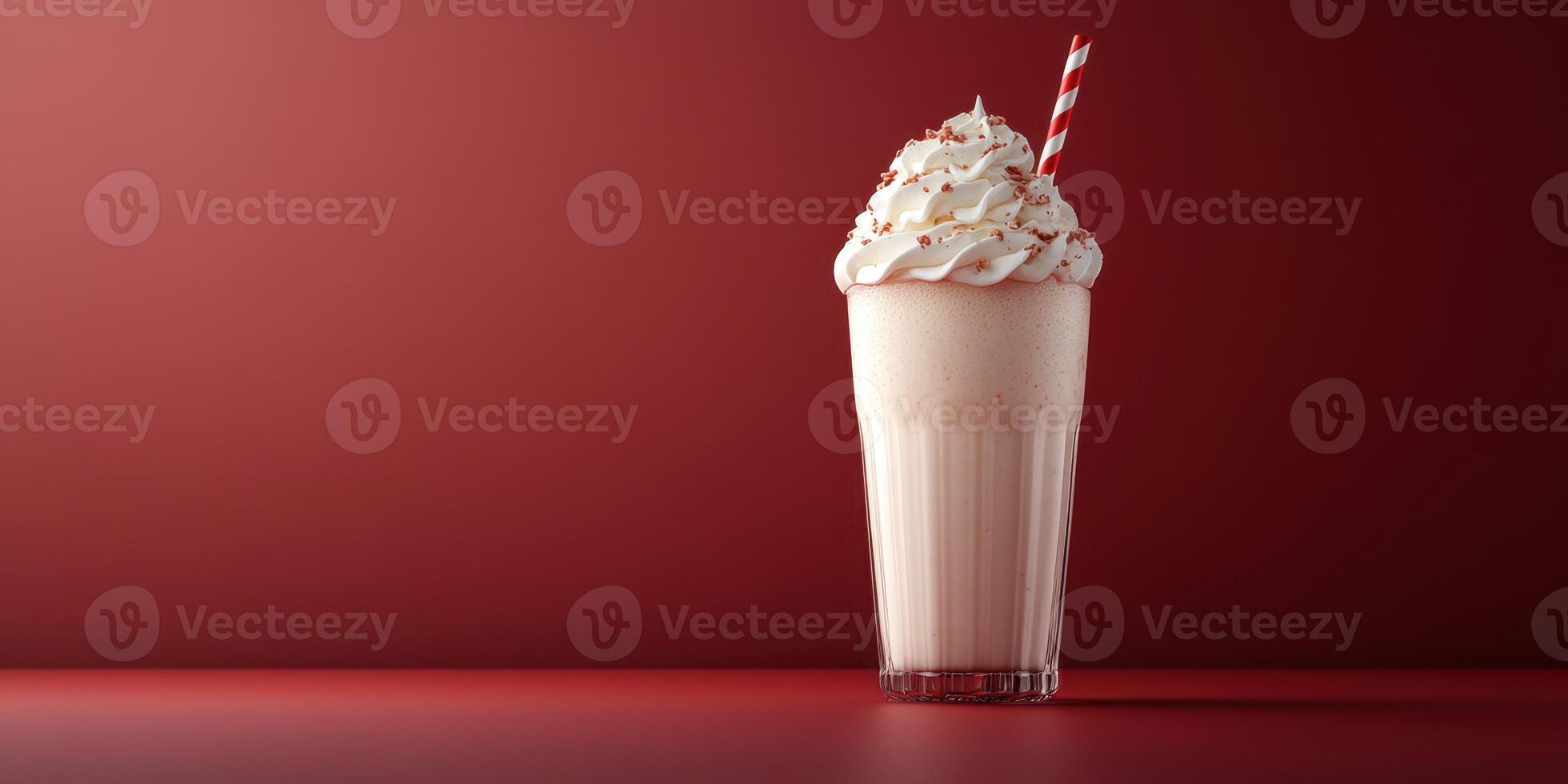 Scent of vanilla and berry swirl in a creamy milkshake served in a tall glass with a striped straw against a red background photo